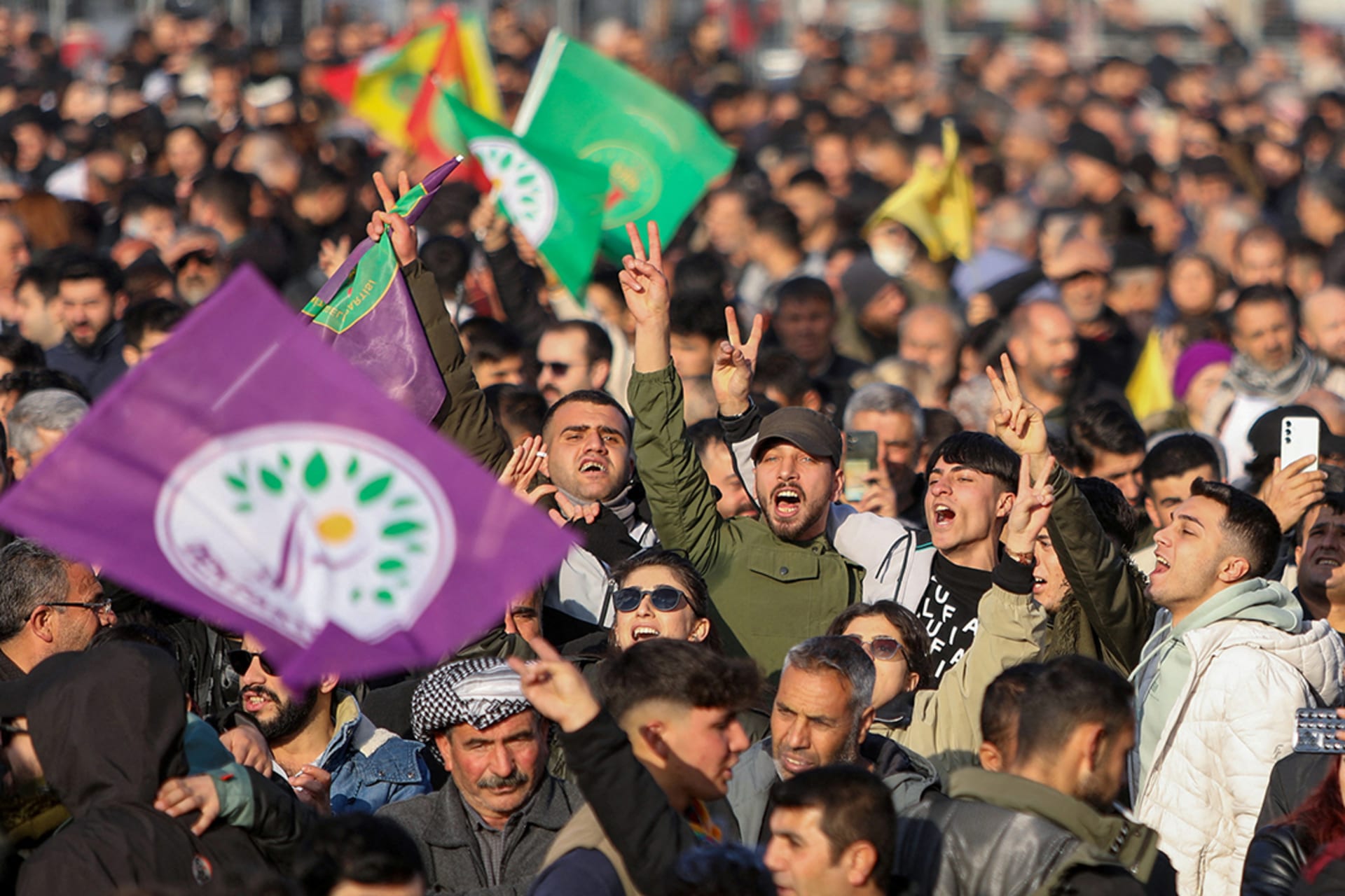 People flash V-signs as they gather to watch a televised press conference of the pro-Kurdish Peoples’ Equality and Democracy Party in Diyarbakir, Turkey. 