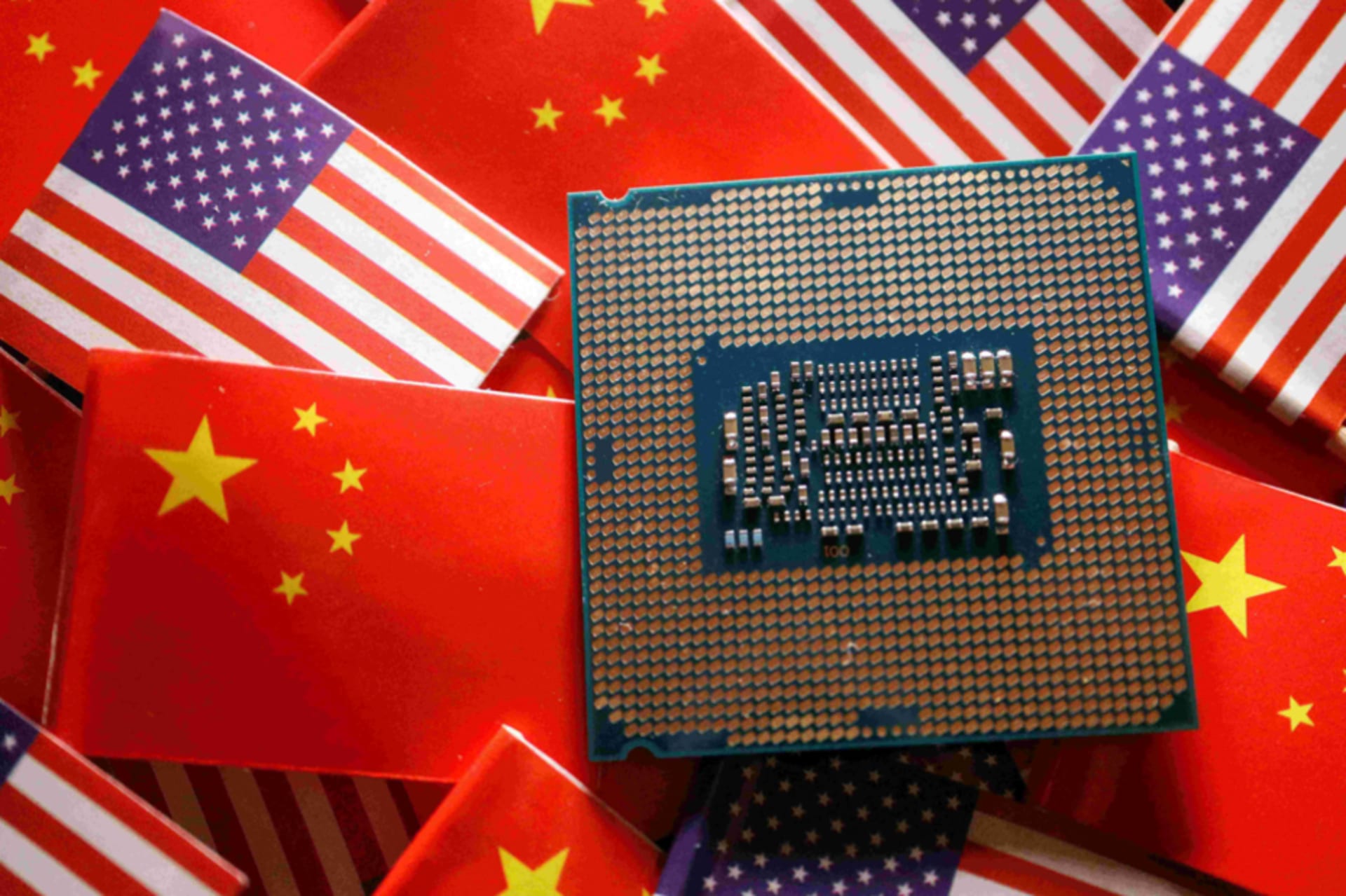 <p>A central processing unit semiconductor chip is displayed among flags of China and U.S., in this illustration picture taken February 17, 2023.</p>
