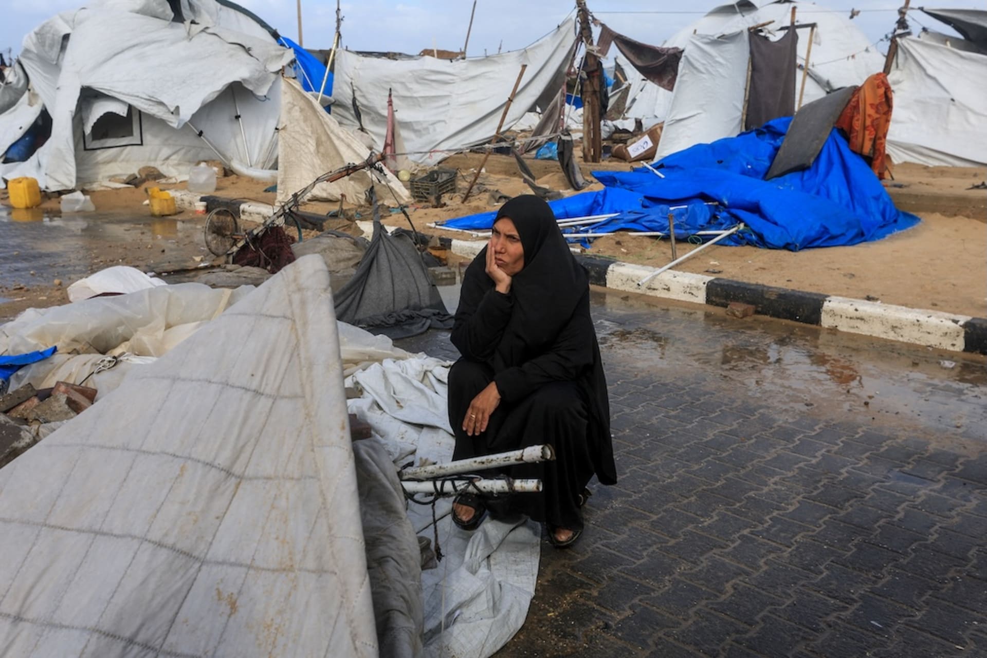 <p>A displaced Palestinian woman sits near damaged tents, amid a windstorm, in Gaza City, January 13, 2026.</p>
