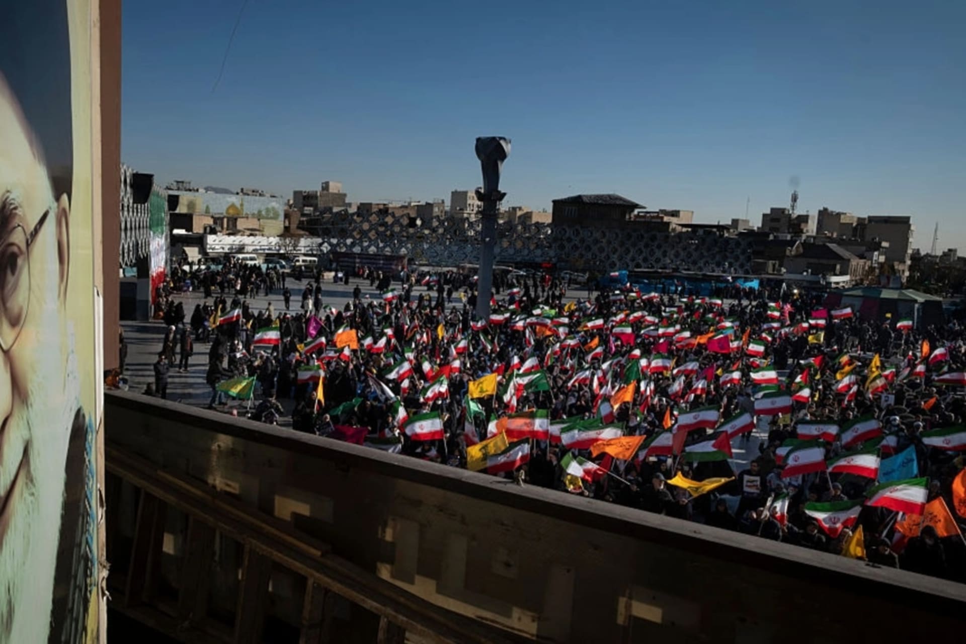 <p>Iranian people hold the national flags next to a portrait of Iran’s Supreme Leader, Ayatollah Ali Khamenei, during a pro-government rally in opposition to the recent protests in Iran in southern Tehran on December 30, 2025.</p>
