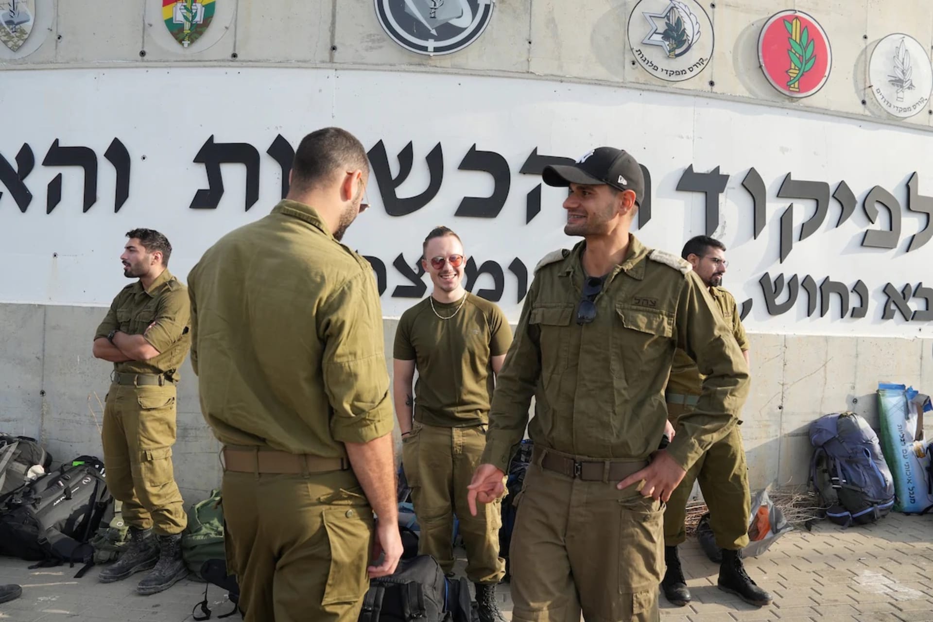 <p>Israeli soldiers great one another as they arrive for reserve duty at the Julia military base near Ashkelon in southern Israel on Wednesday.</p>
