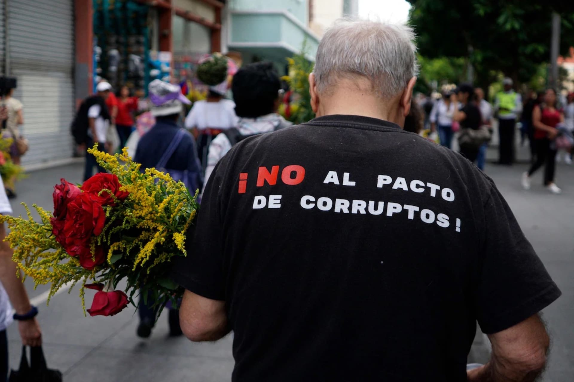 <p>A man wearing a T-shirt that reads “No to the pact of corrupt people!” marches to demand the resignation of judicial officials accused of generating an electoral crisis ahead of a runoff vote in Guatemala City on July 28.</p>
