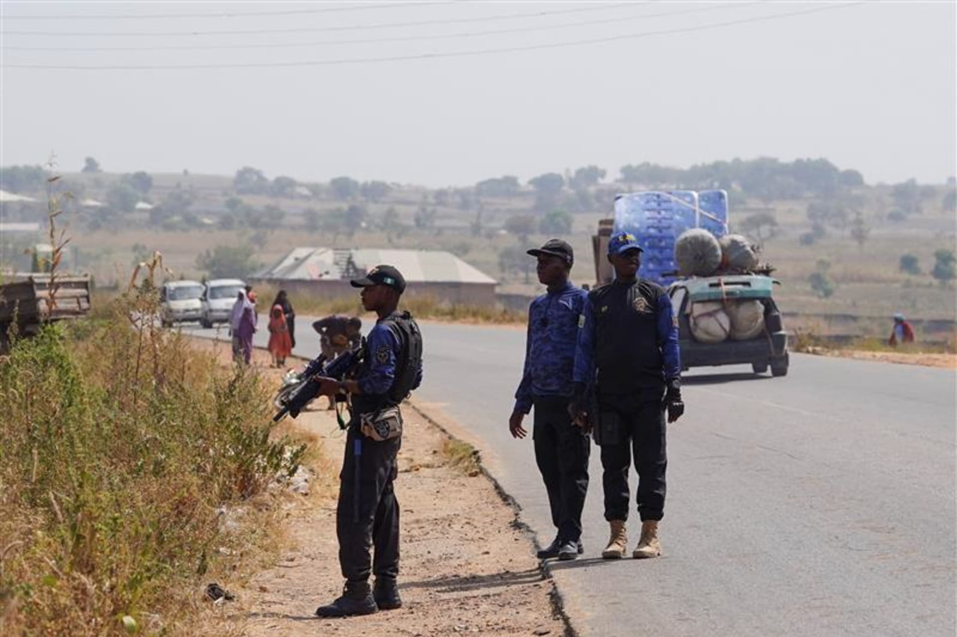 <p>Members of the Civilian Joint Task Force stand guard during a drill near a bush in Minna, Niger state, Nigeria, on November 29, 2025. Vigilante groups have stepped in to fill security gaps as rural communities face rising attacks and abductions by armed gangs.</p>
