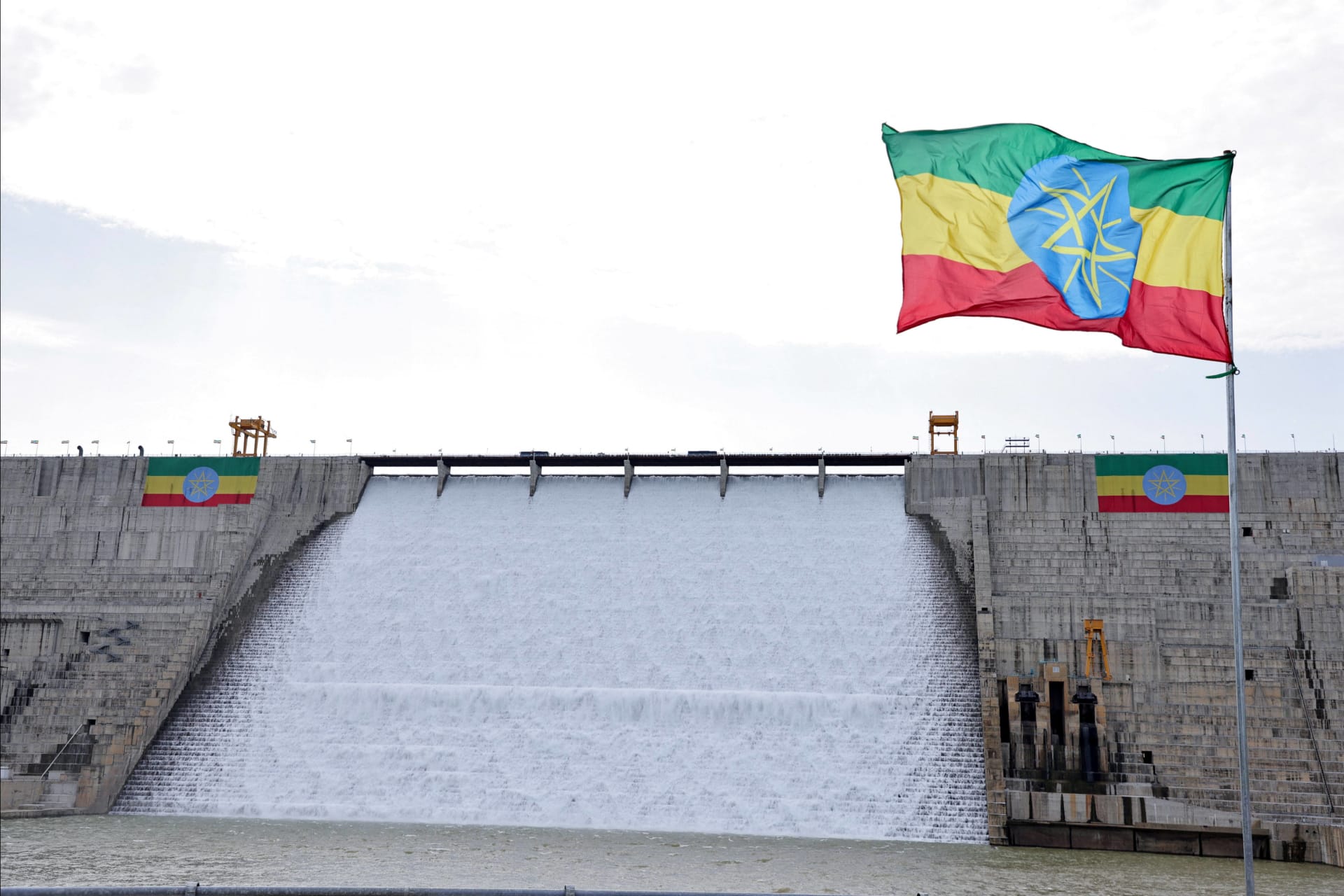 An Ethiopian flag flutters in the wind next to the Grand Ethiopian Renaissance Dam, built along the Blue Nile, during its inauguration in Guba, Ethiopia on September 9, 2025.