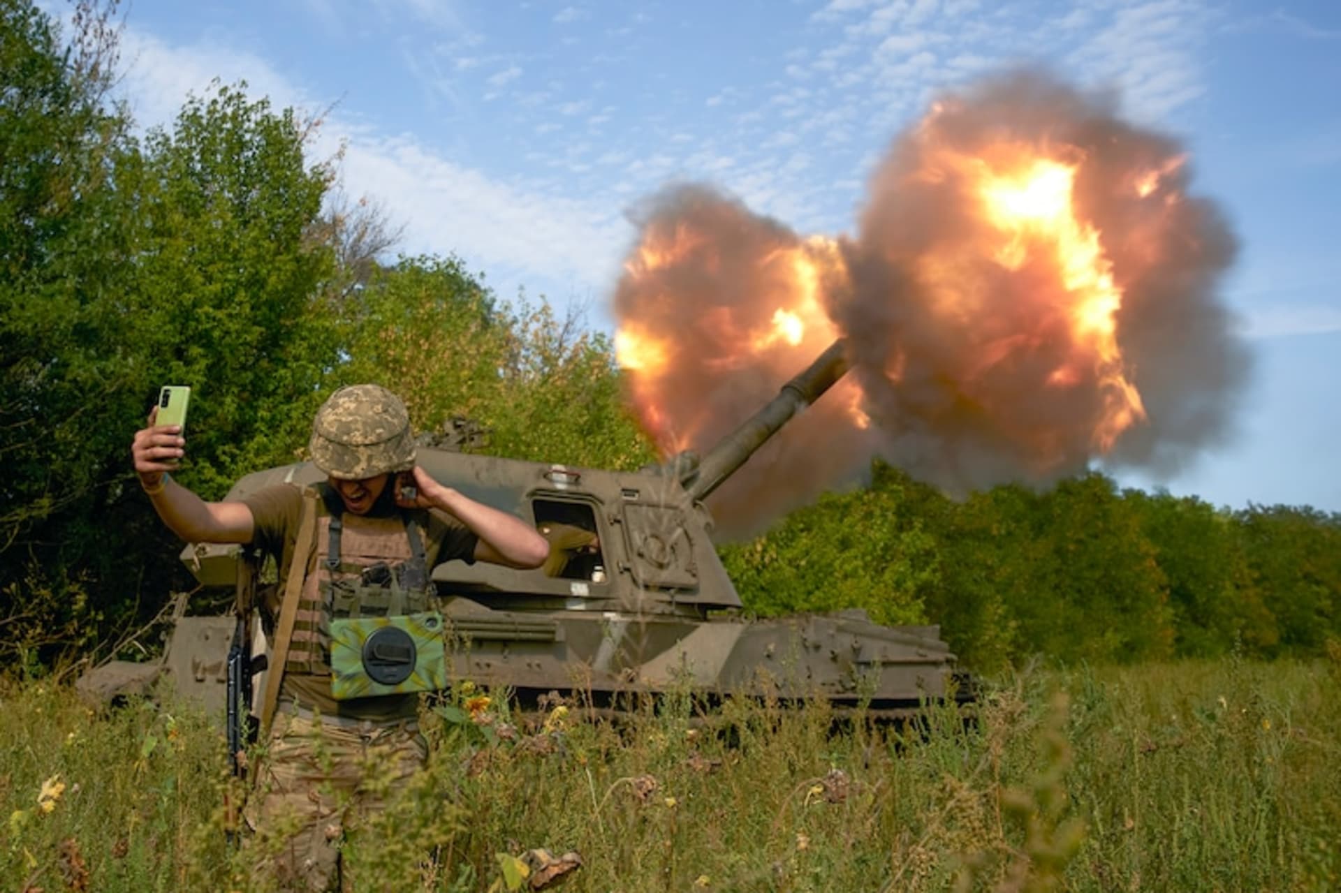 <p>A Ukrainian soldier takes a selfie as an artillery system fires in the Donetsk region, eastern Ukraine, on Sept. 3. </p>
