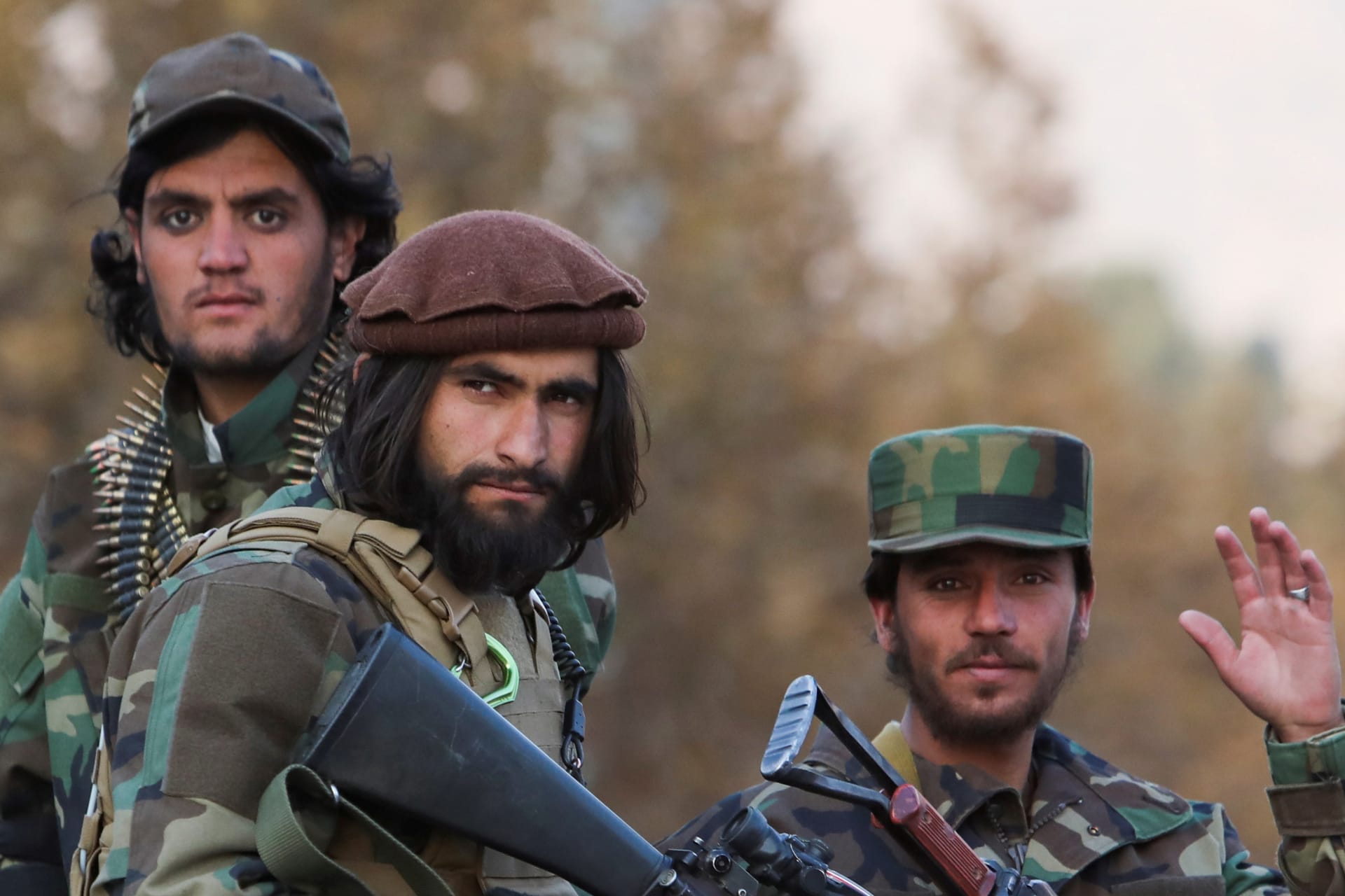 Members of Taliban sit on a military vehicle during Taliban military parade in Kabul