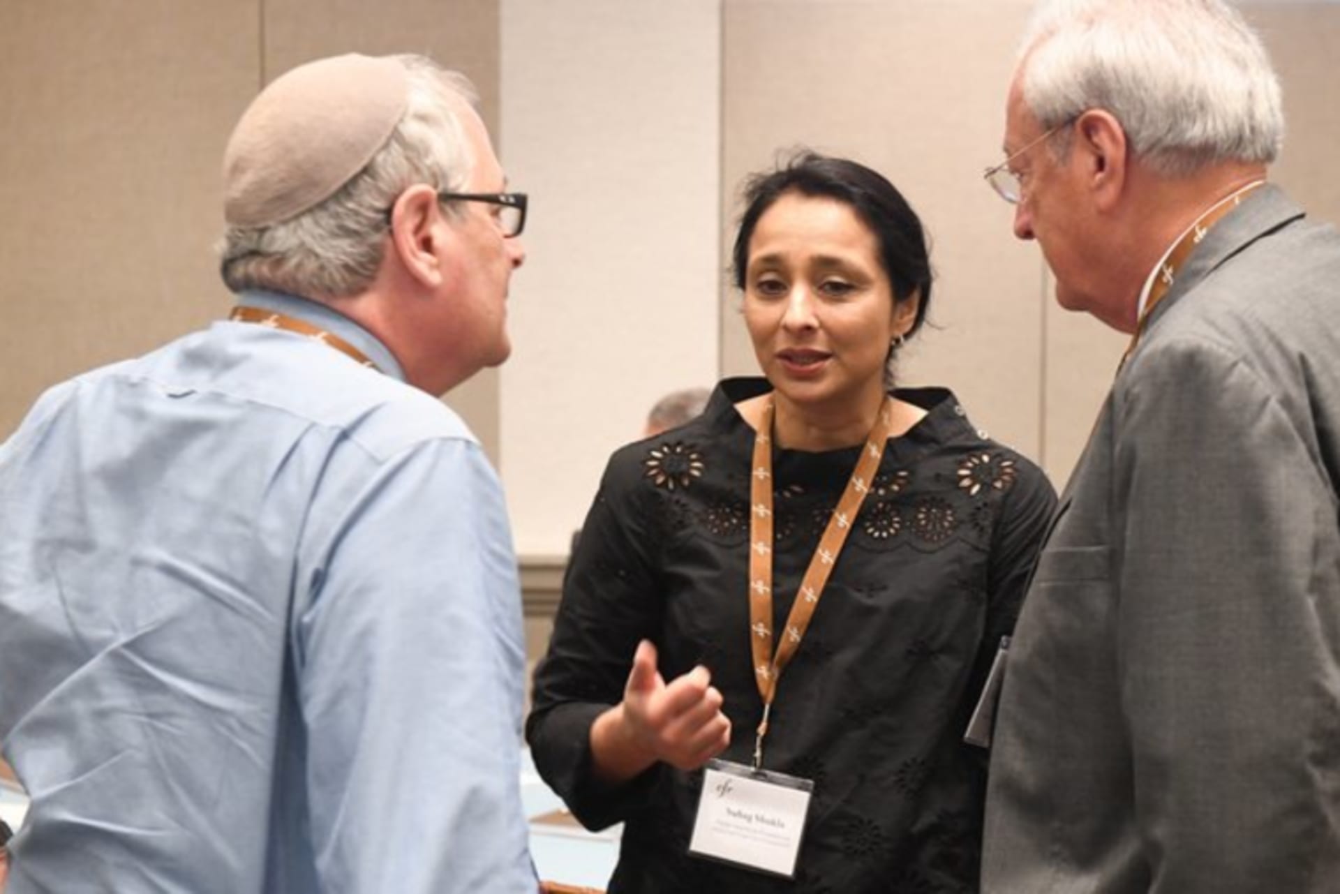 Three people talking during Religion Program meeting