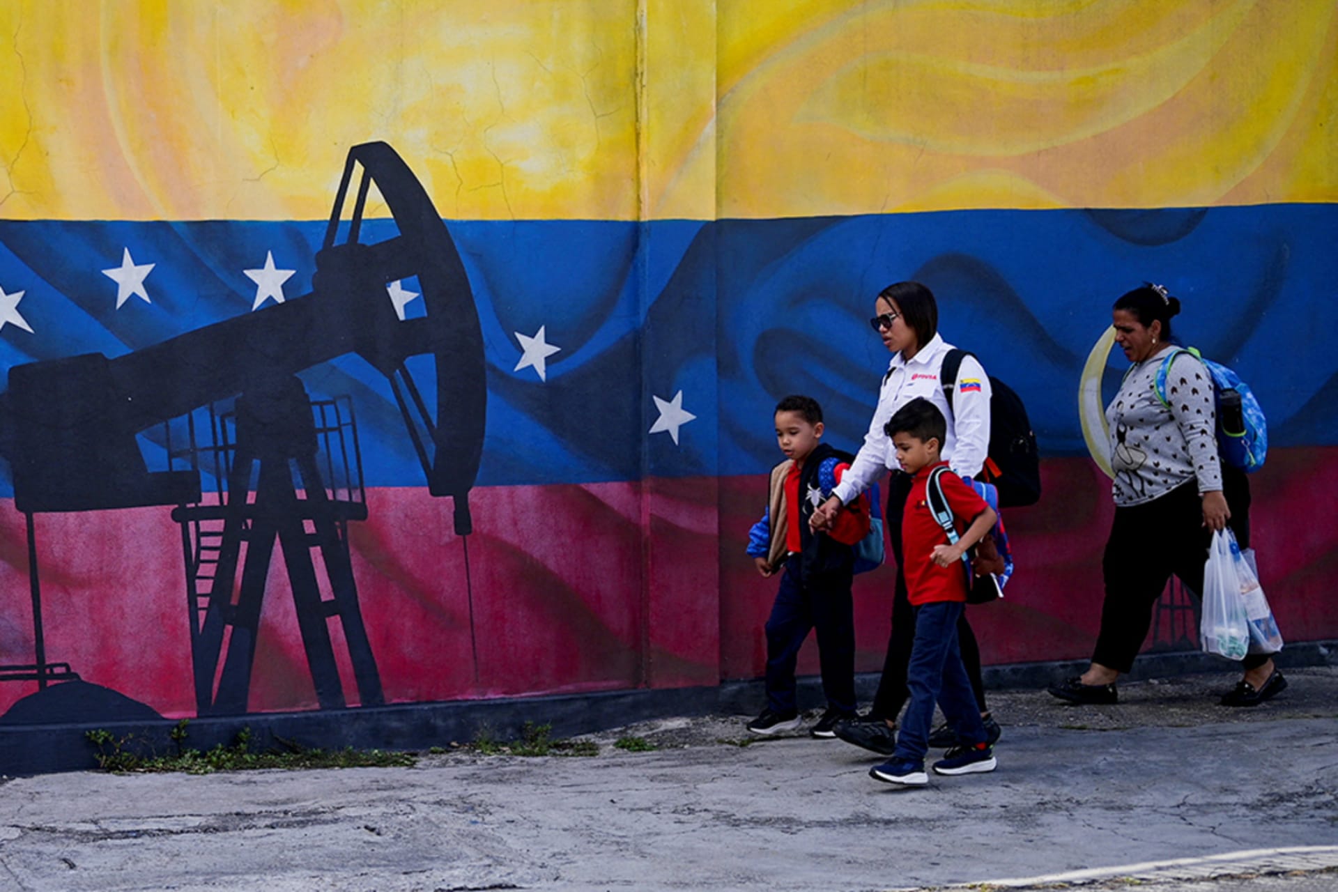 <div class="c-message_kit__blocks c-message_kit__blocks--rich_text">
<div class="c-message__message_blocks c-message__message_blocks--rich_text" data-qa="message-text">
<div class="p-block_kit_renderer" data-qa="block-kit-renderer">
<div class="p-block_kit_renderer__block_wrapper p-block_kit_renderer__block_wrapper--first">
<div class="p-rich_text_block" dir="auto">
<div class="p-rich_text_section">People walk past a painting of an oil pump on Venezuela<span style="font-weight: 400;">’</span>s national flag, in Caracas, Venezuela, January 13, 2026.</div>
</div>
</div>
</div>
</div>
</div>
<div class="c-files_container" role="none" data-qa="message_kit_files">
<div class="c-message_kit__file">
<div class="c-message_kit__file__meta"></div>
</div>
</div>
