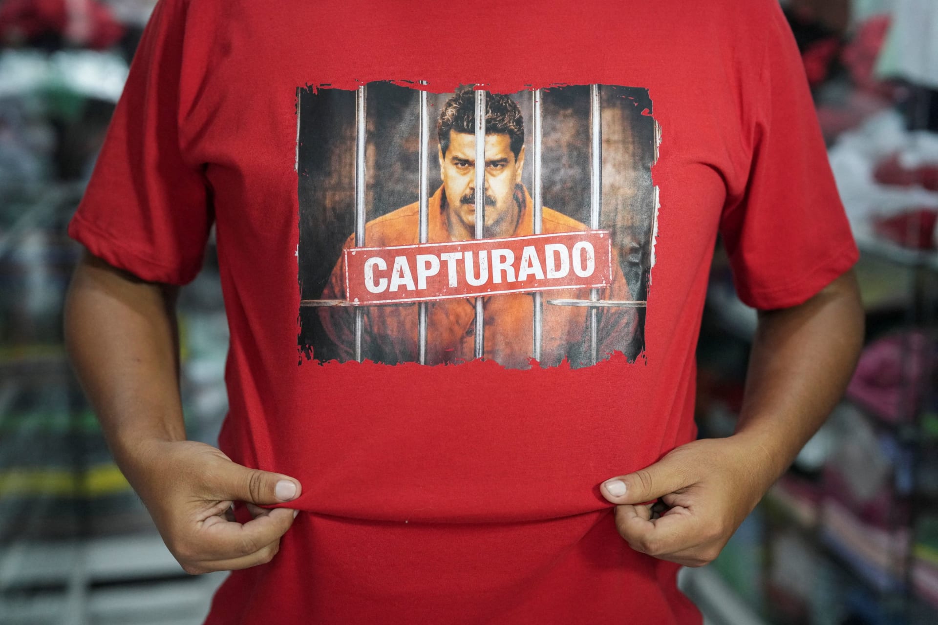 Photo of Venezuelan migrant in Peru with shirt showing Maduro captured