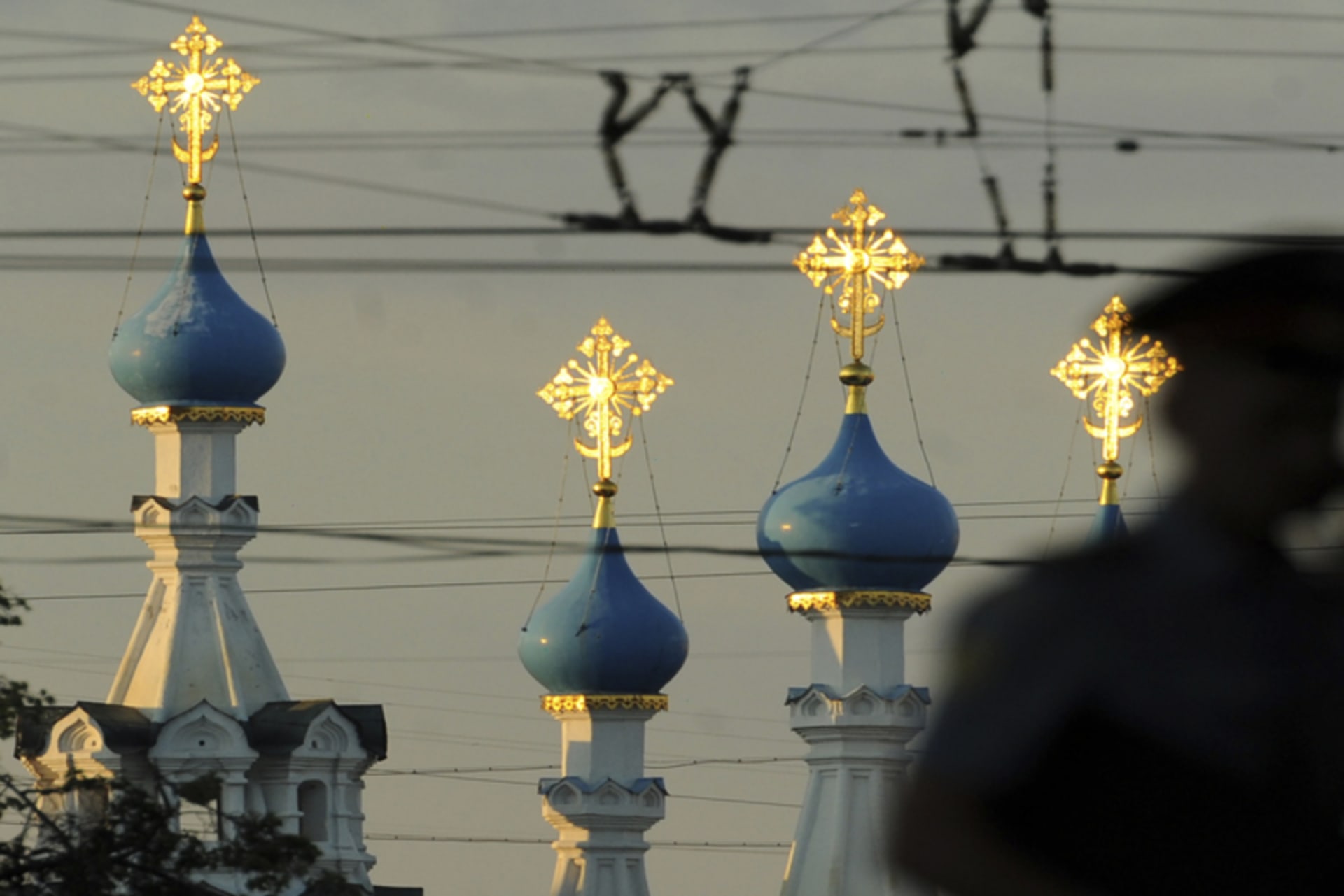 A Russian policeman passes an Orthodox church during a demonstration to support political prisoners in Moscow