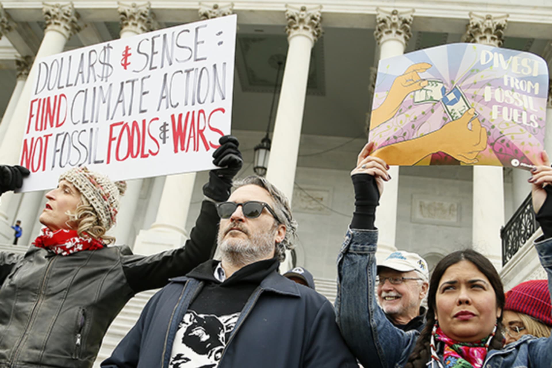 <p>Actor Joaquin Phoenix (center) stands with protestors waiting to be arrested on the steps of the U.S. Capitol Building during a climate change protest and rally on Capitol Hill on January 10, 2020 in Washington, D.C.</p>
