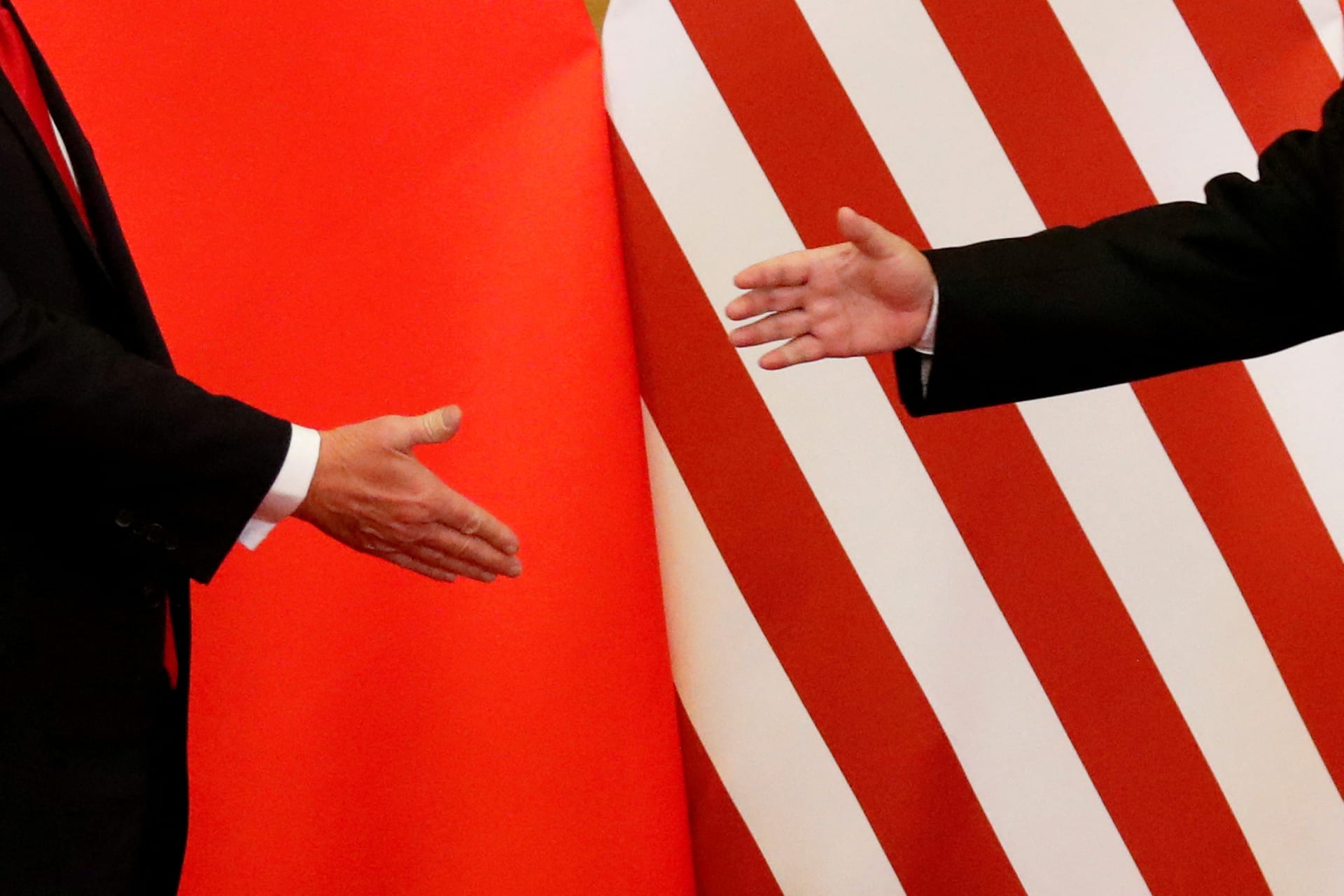 U.S. President Donald Trump and China's President Xi Jinping shake hands