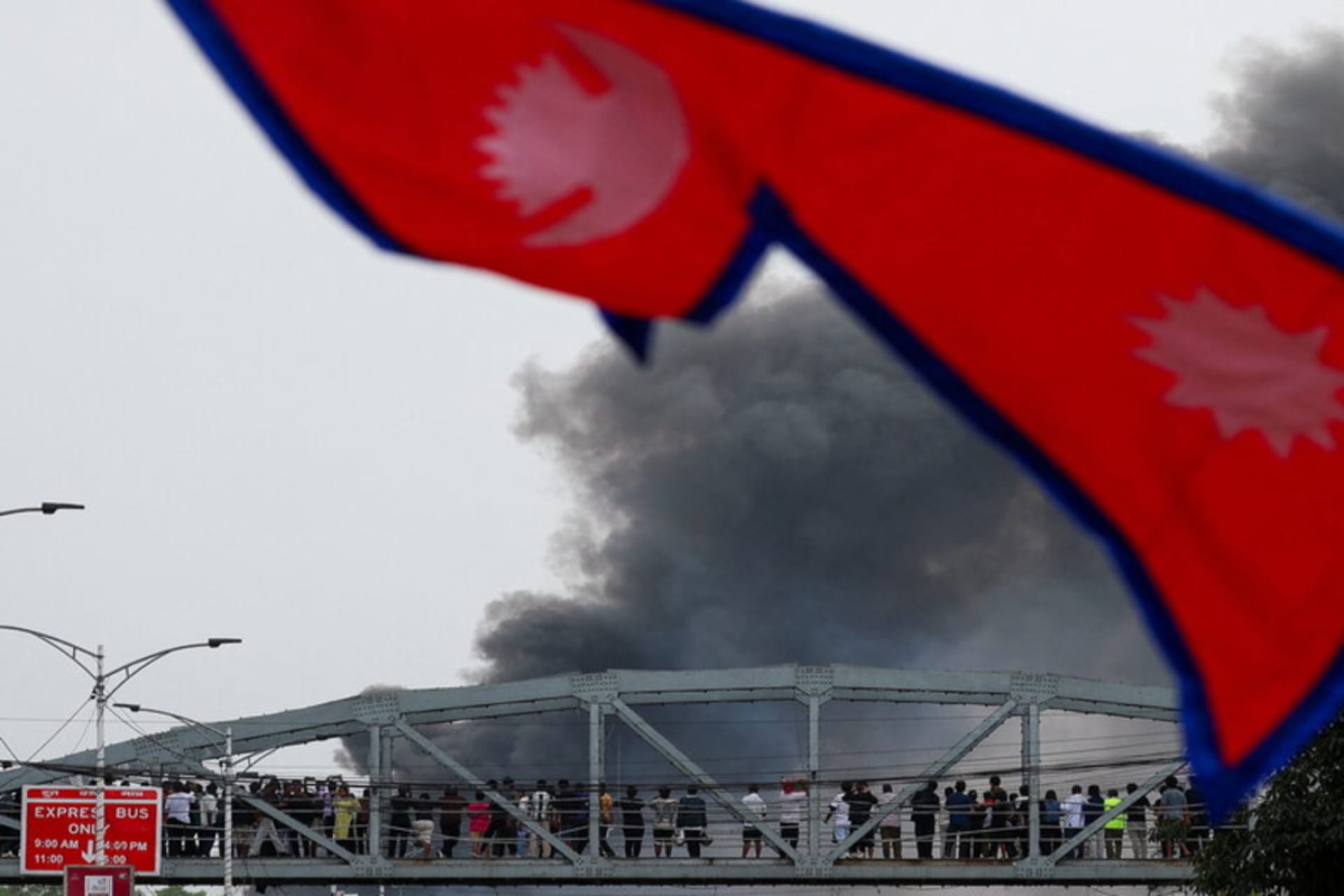 <p>Smoke rises after demonstrators set the main gate of the Parliament on fire, during a protest against Monday’s killing of 19 people after anti-corruption protests that were triggered by a social media ban, which was later lifted, during a curfew in Kathma</p>