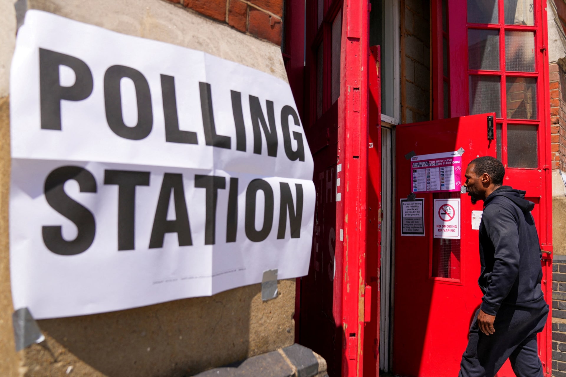 A man enters a polling station during the general election in London, Britain July 4, 2024.