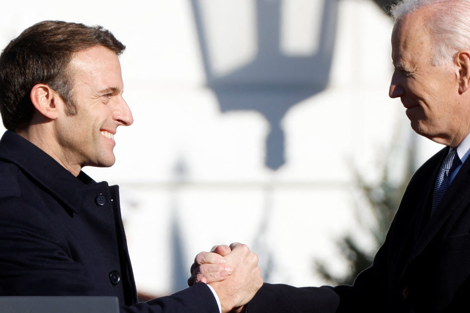 French President Emmanuel Macron greets U.S. President Joe Biden