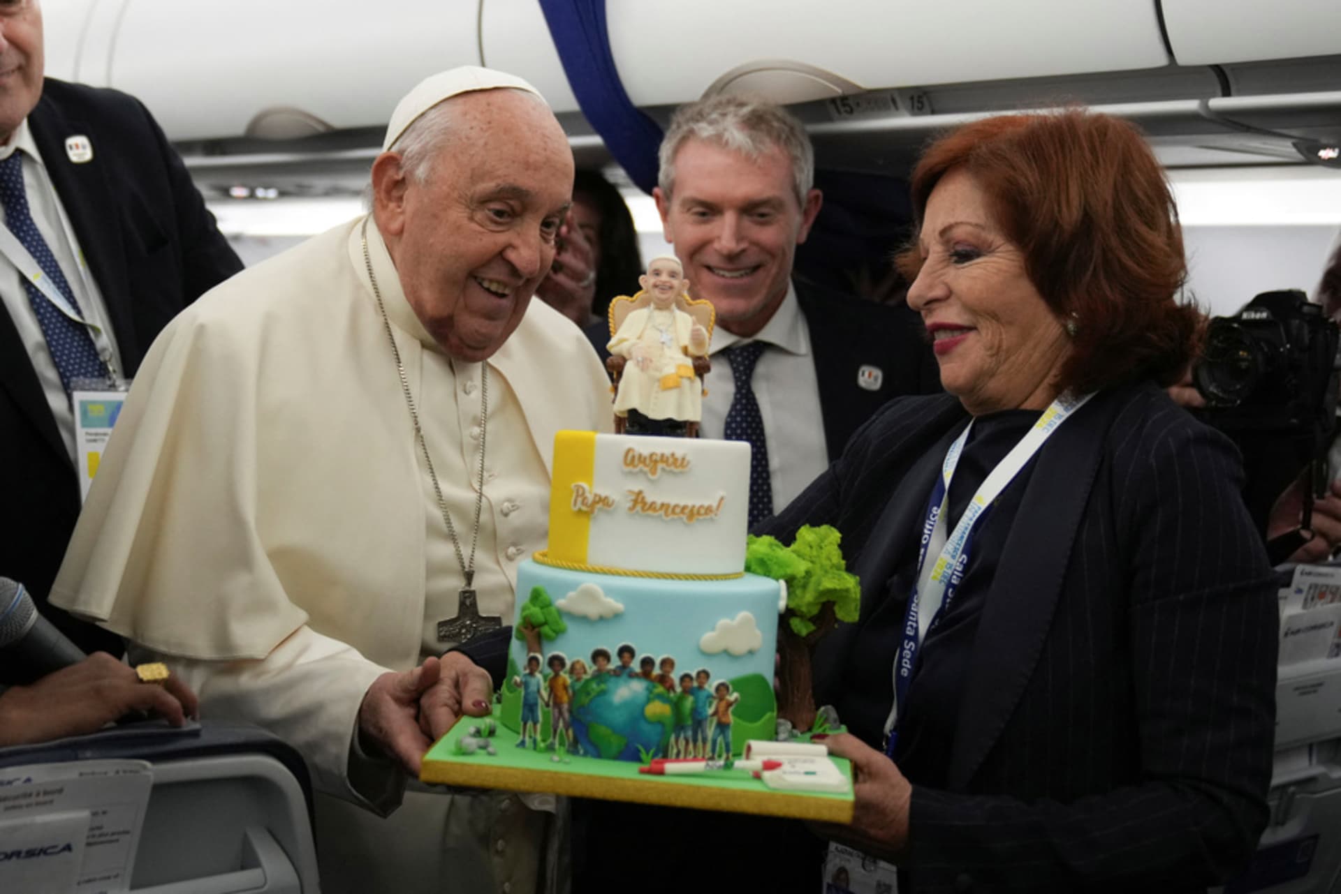 <p>Pope Francis is presented with a cake by Valentina Alazraki, correspondent for TeleVisa Univision, to celebrate his upcoming 88th birthday, on the flight back to Rome at the end of his one-day visit to Ajaccio in the French island of Corsica, December 15,</p>
