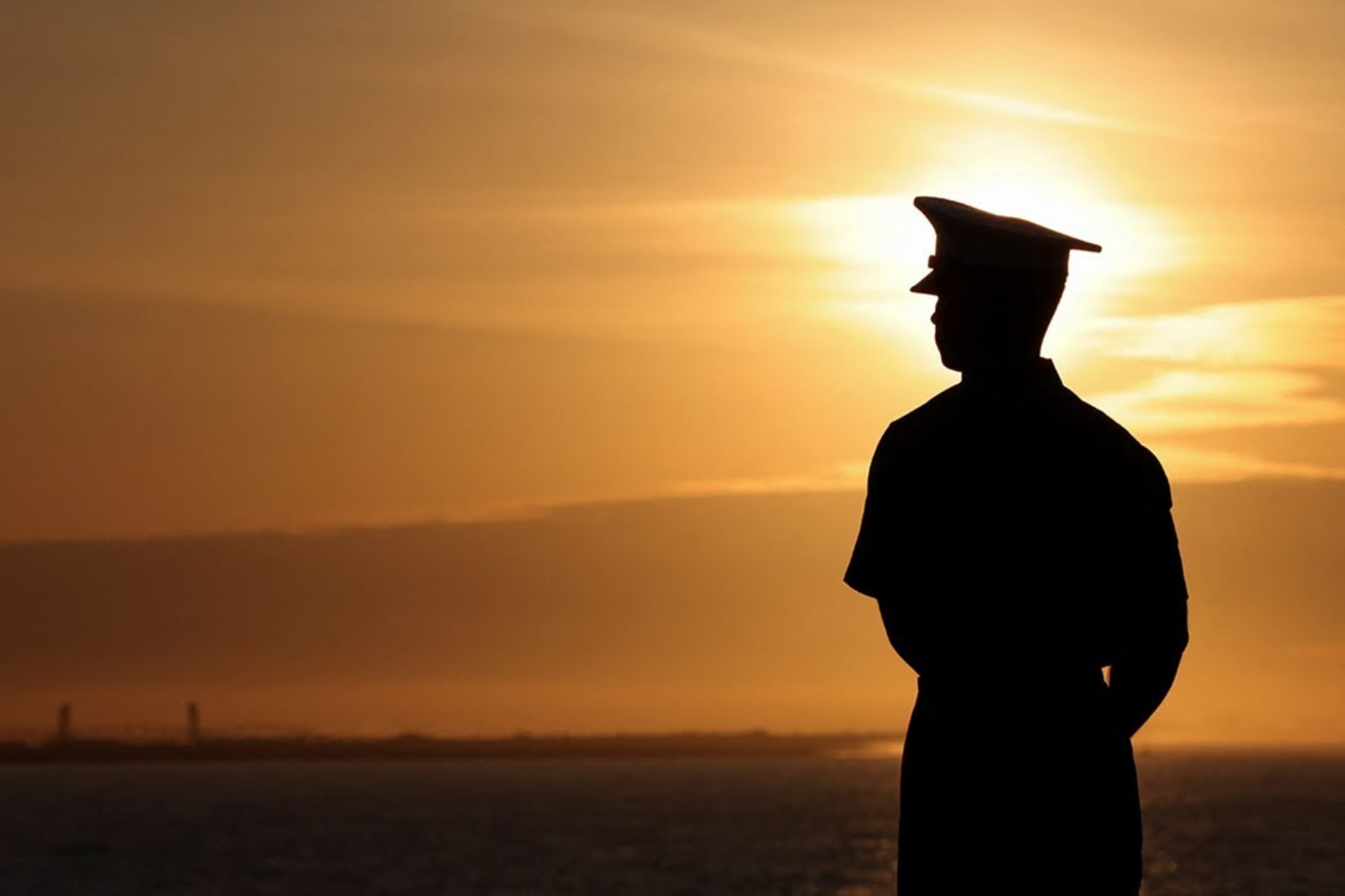 marine looking at coastal sunset