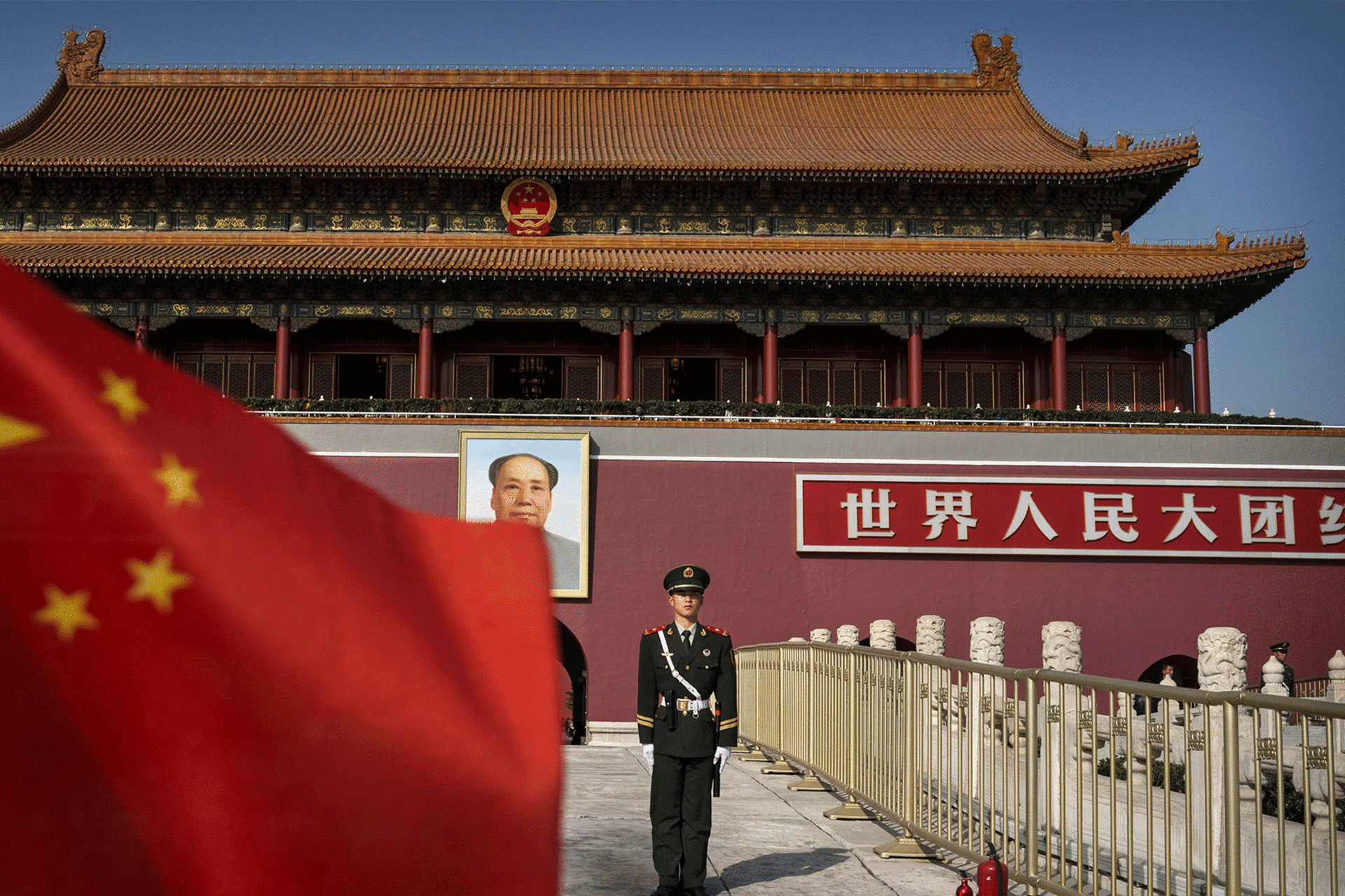 Chinese soldier stands in front of the gates to the Forbidden City in Beijing, China
