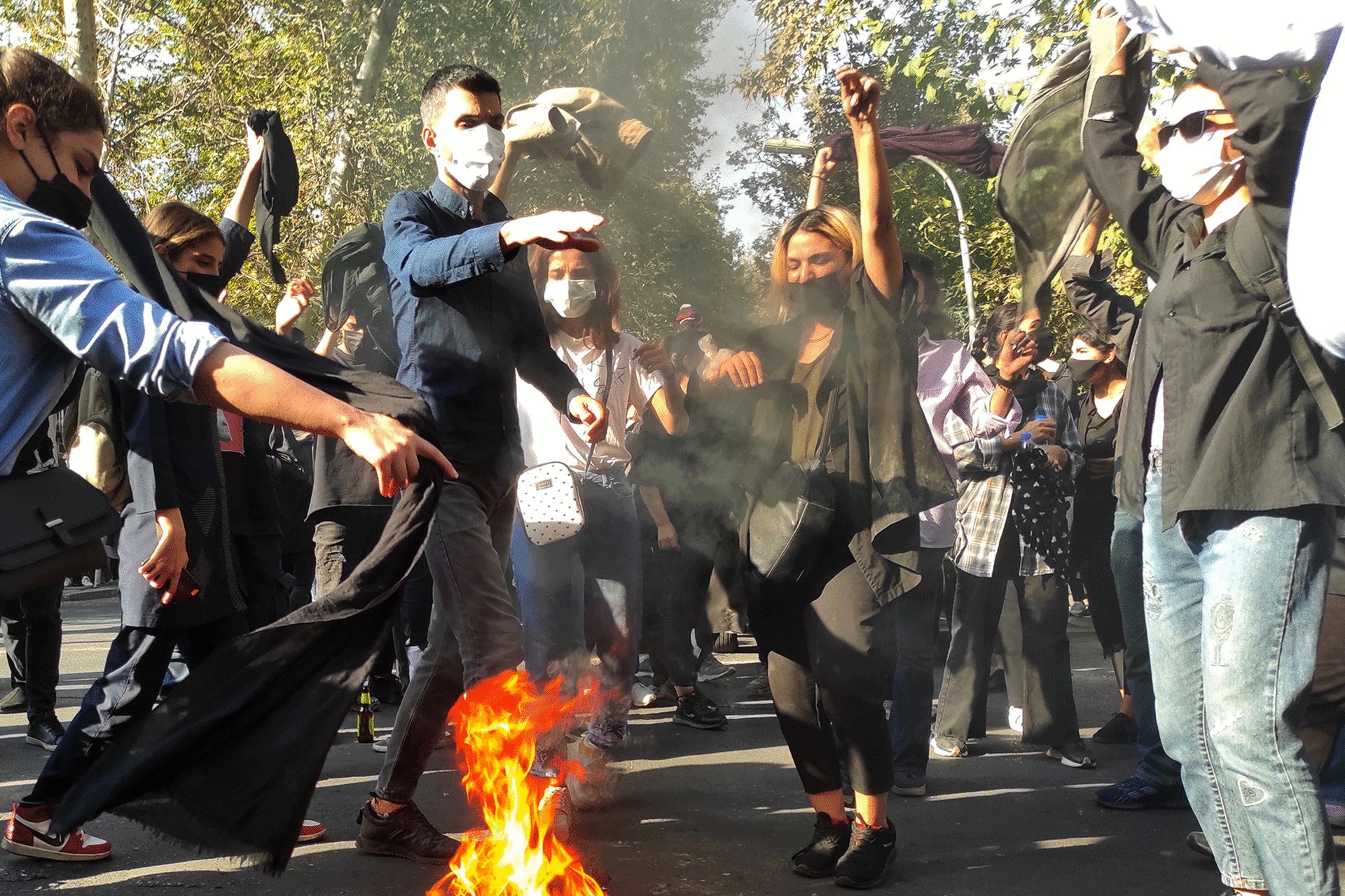 Iranian protestors burning headscarfs