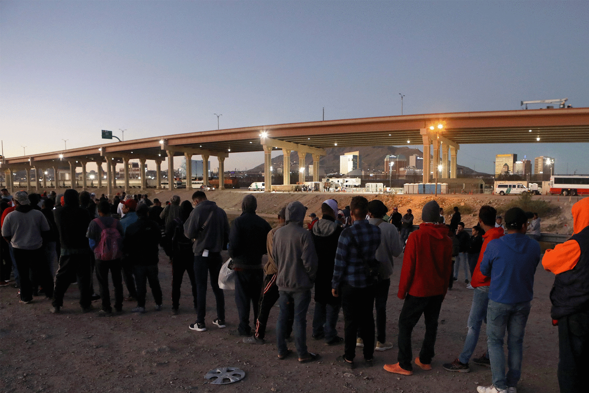 Venezuelan migrants stand in front of the US Border Patrol operations