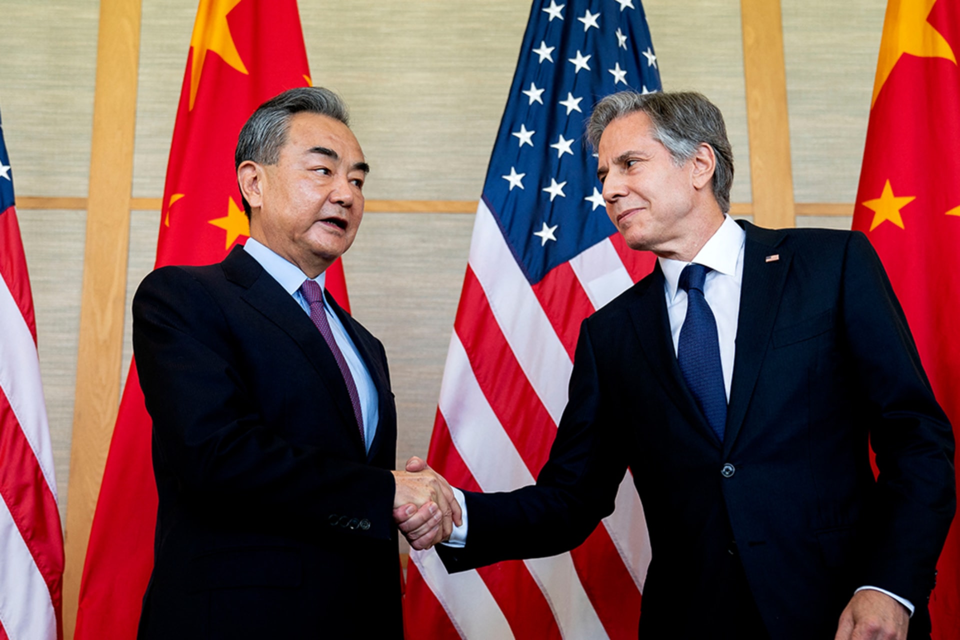Blinken and Yi shake hands