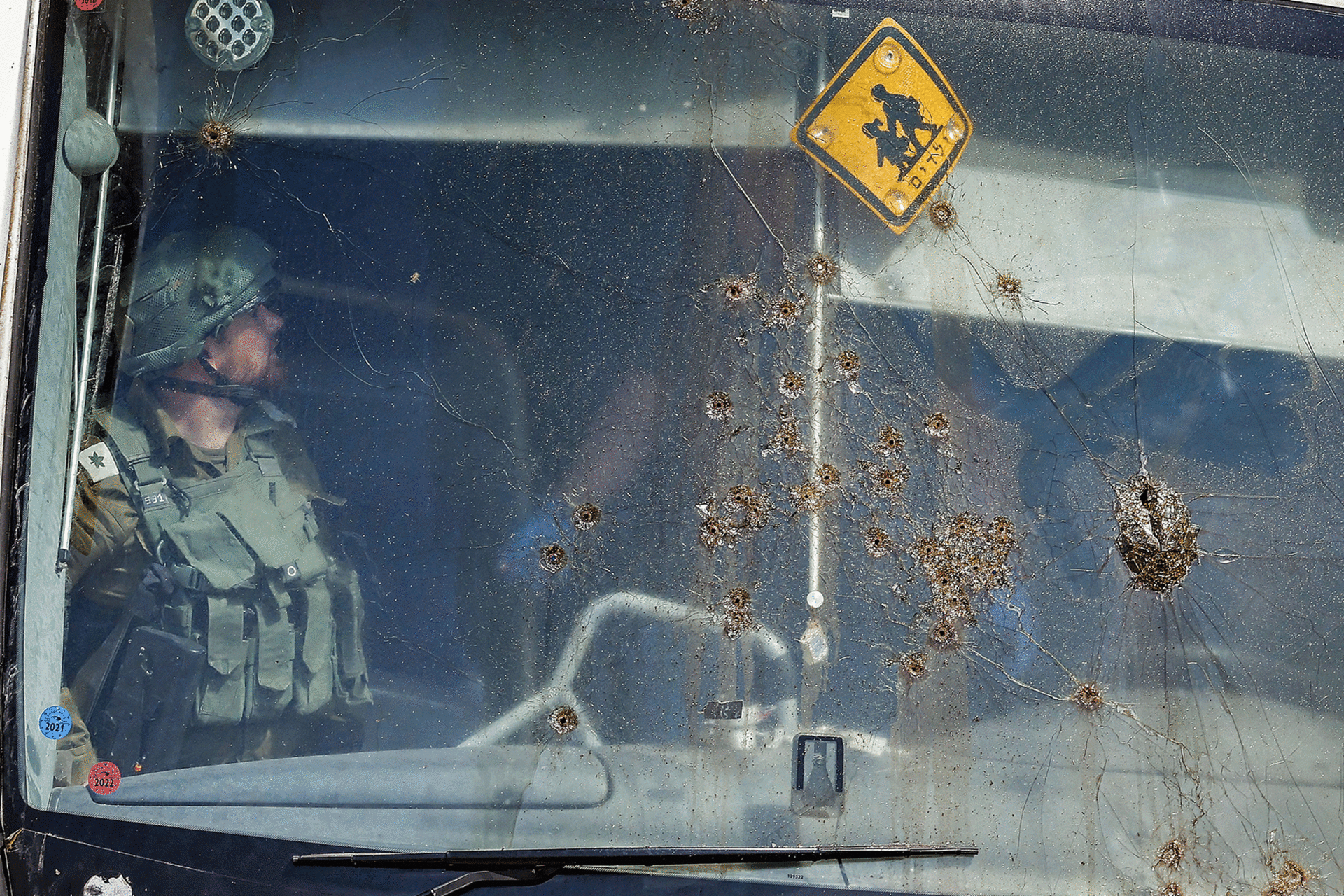 Members of Israeli security forces and emergency services inspect the site of a reported attack on an Israeli bus