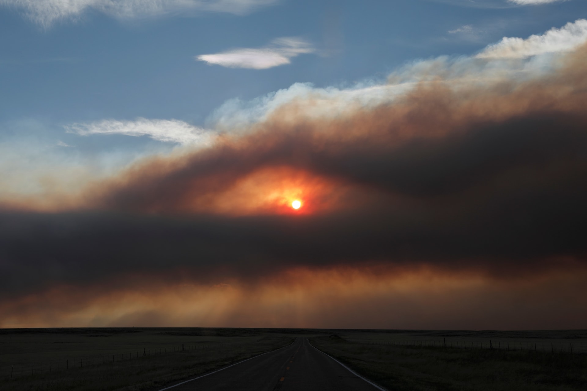 <p>A general view of the landscape with plumes of smoke from the Hermits Peak and Calf Canyon fires filling the sky, near Ocate, New Mexico</p>
