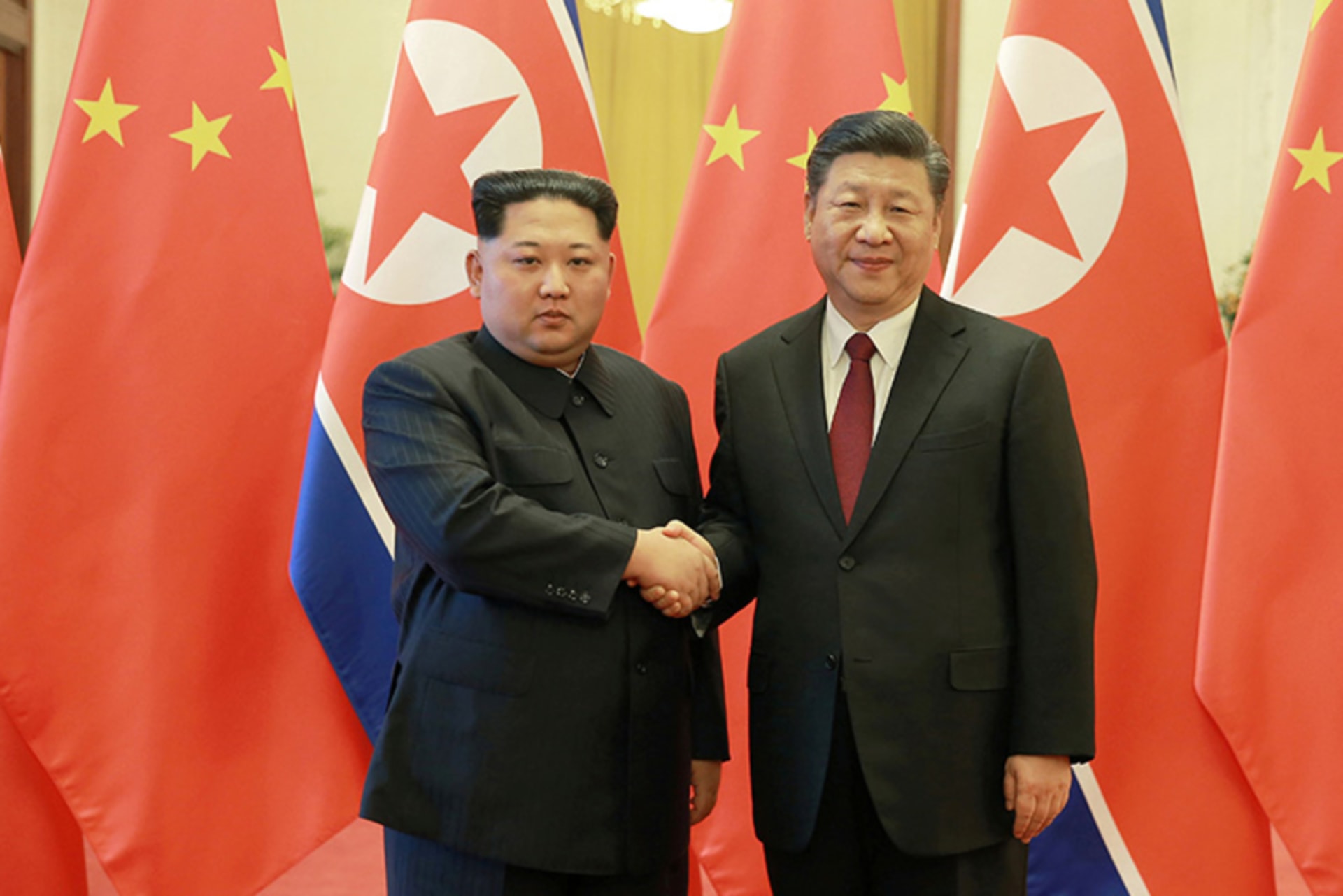 North Korean leader Kim Jong Un shakes hands with Chinese President Xi Jinping