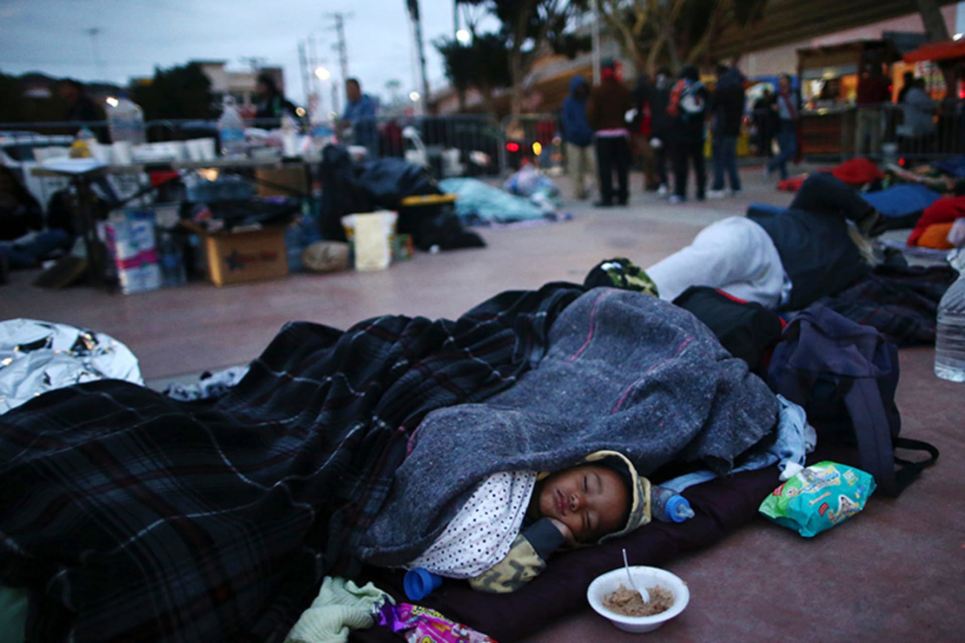 Members of a caravan of migrants from Central America sleep near the San Ysidro checkpoint