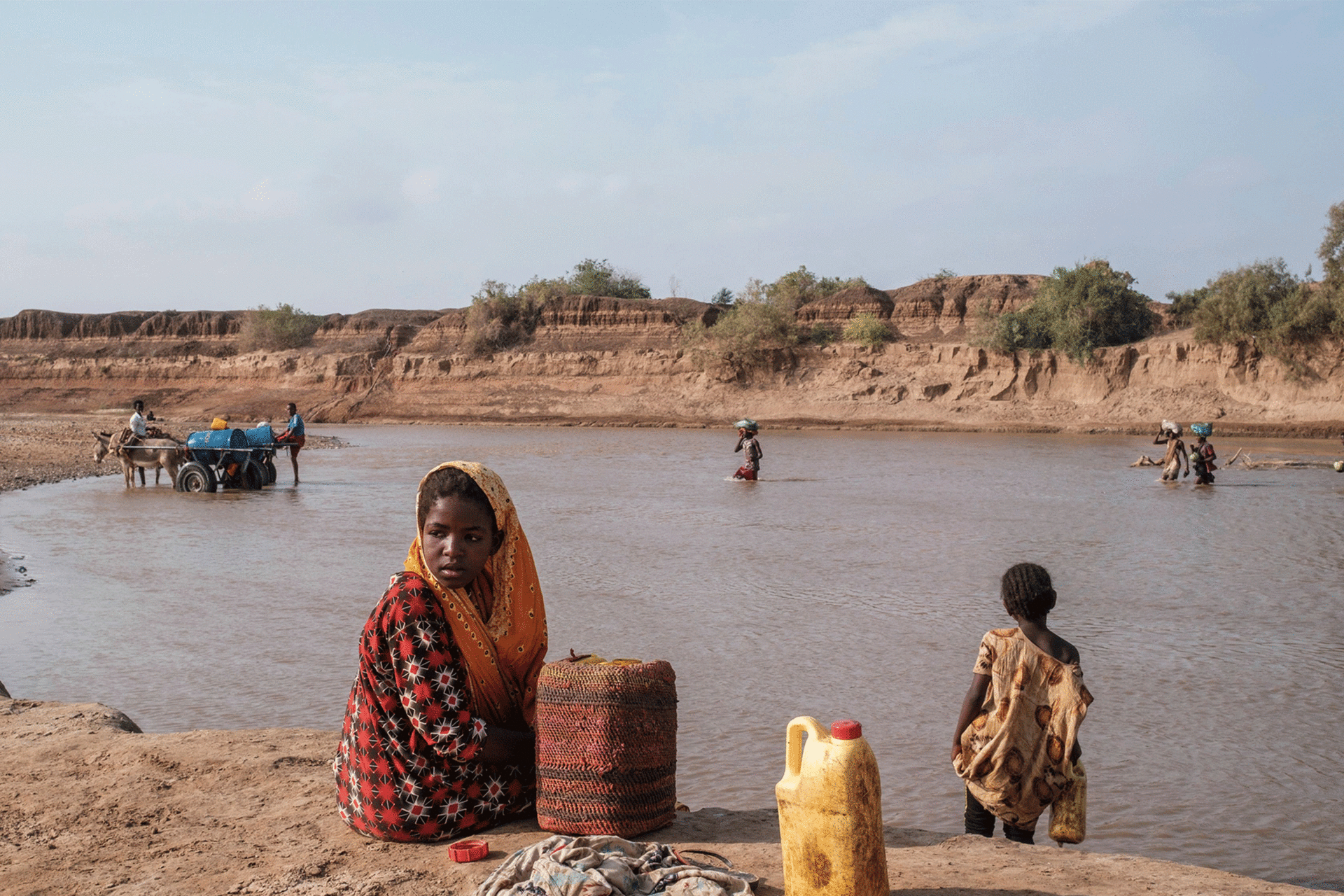 A girl looks on as she sits on the shore of the Shabelle river in the city of Gode, Ethiopia