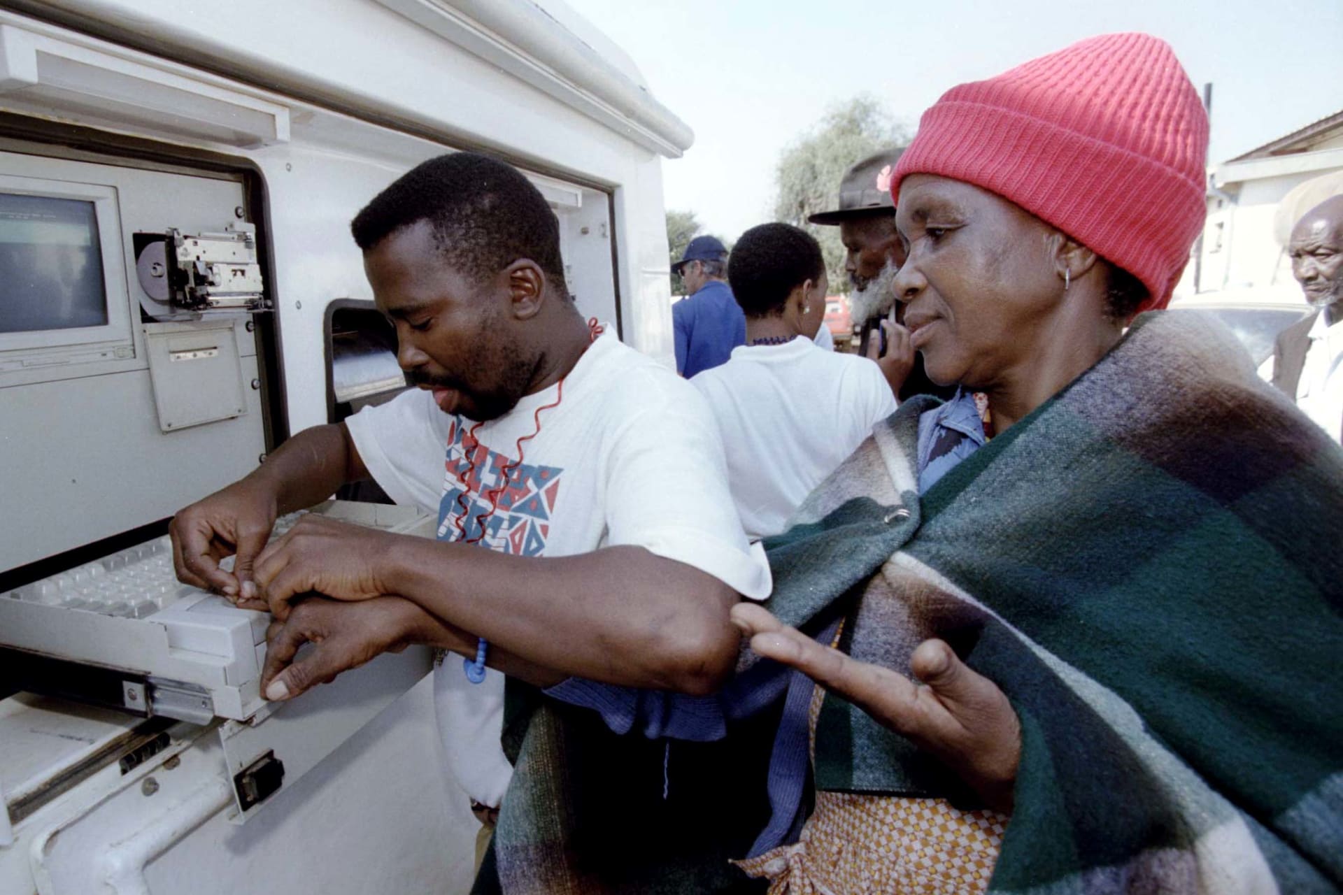<p> A bank operator takes the fingerprint of a South African woman at a mobile cash dispenser in this township of the remote former homeland of KwaNdebele May 10.</p>
