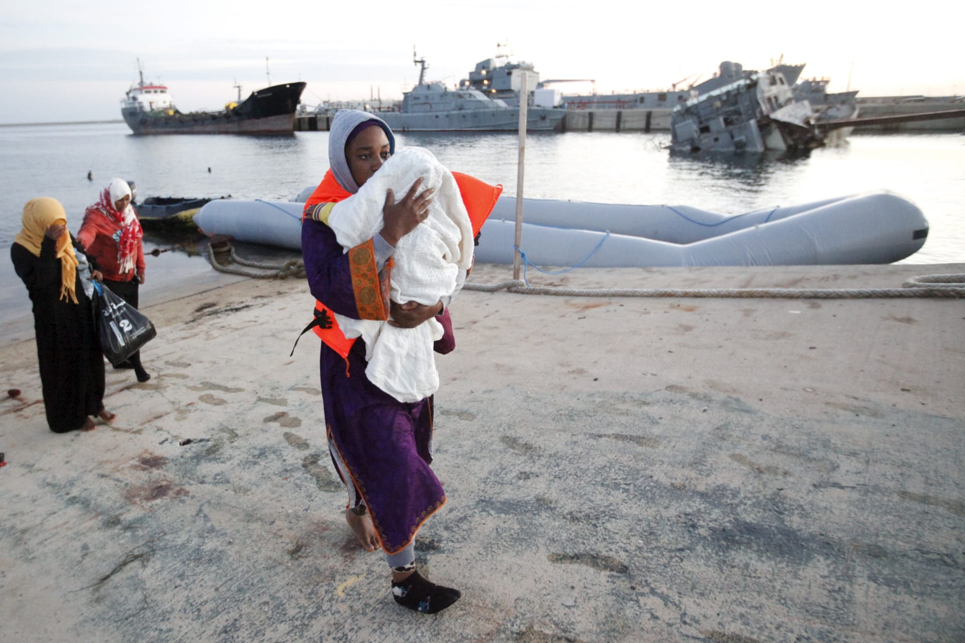 <p>Migrants disembark a Libyan Navy boat at a base in Tripoli, Libya, after they were stopped by Libyan coast guards. Libya has become a major hub for human traffickers smuggling African migrants by boat to Italy. September 29, 2015.</p>
