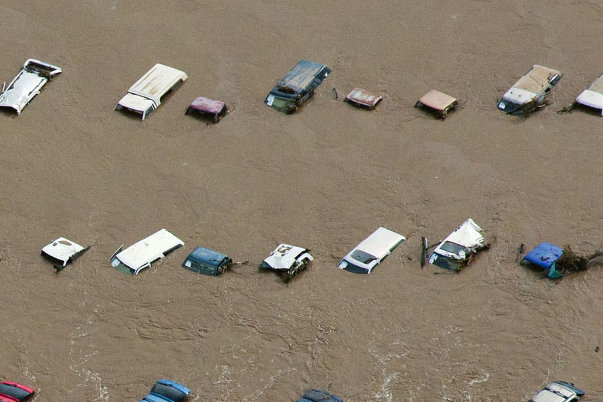An aerial view of vehicles submerged in flood waters along the Sough Platte River near Greenley