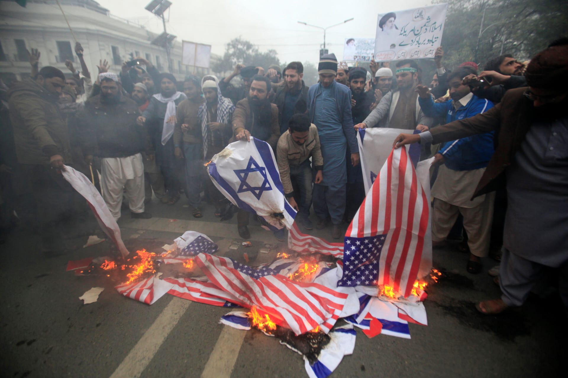 <p>Protesters burn American and Israeli flags during a protest in response to U.S. President Donald Trump’s recognition of Jerusalem as Israel’s capital. (MOHSIN RAZA / REUTERS)</p>
