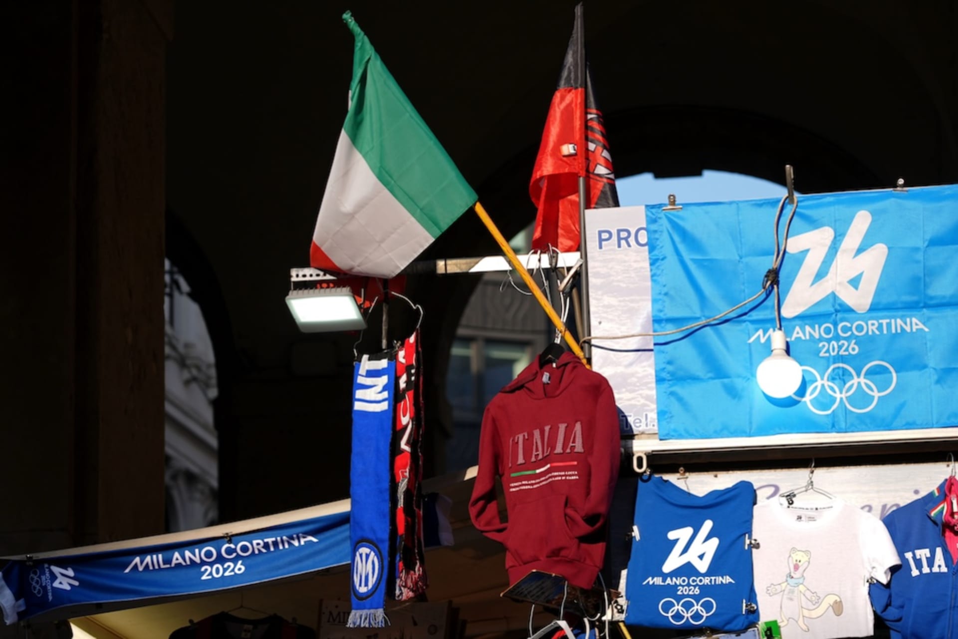 <p>A street vendor sells Olympics apparel and other Italian themed items ahead of the Milano Cortina 2026 Olympic Winter Games, Feb 1, 2026 in Milan, Italy. </p>
