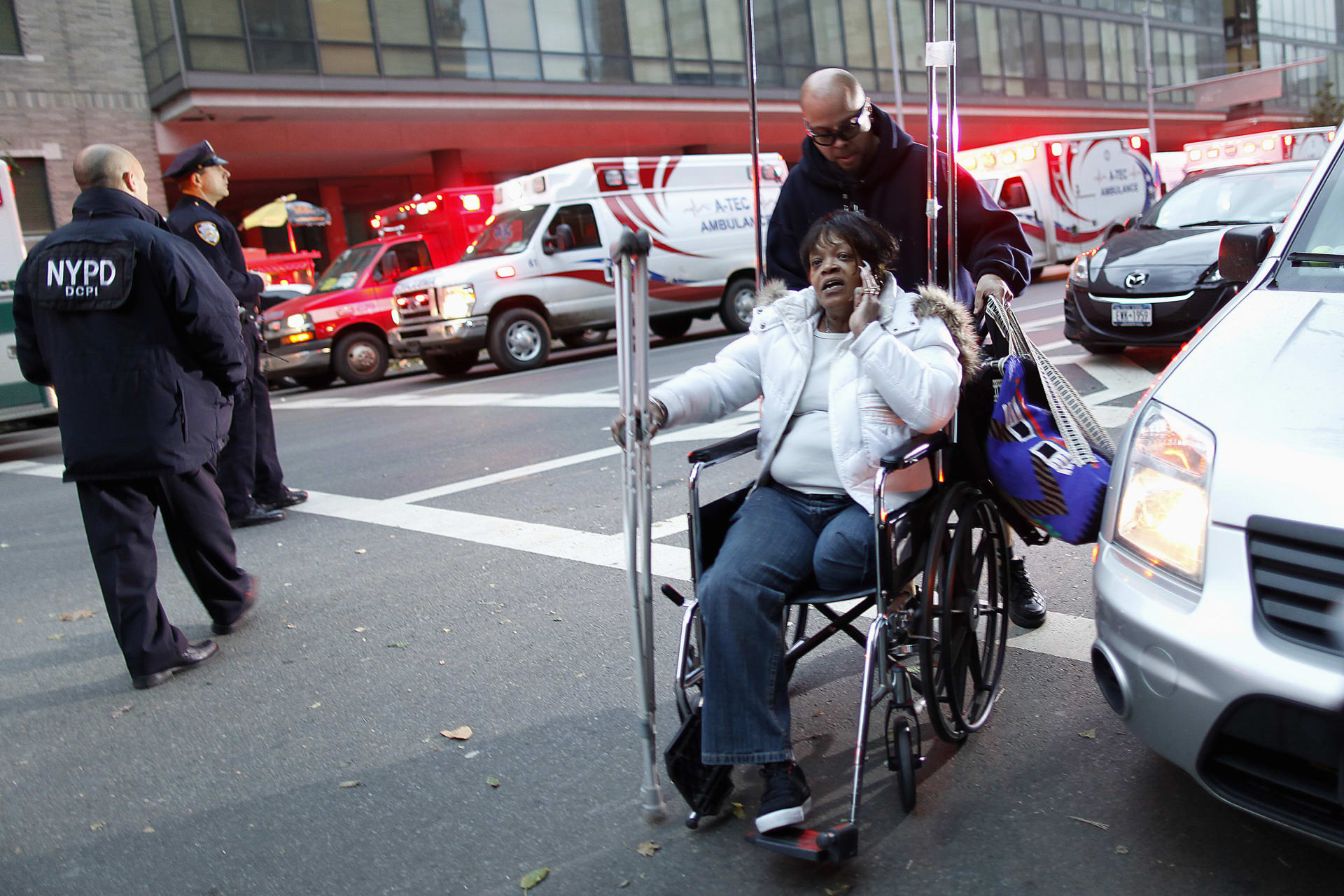 Barbara Fleming is evacuated from Bellevue Hospital by Victor Rivera who works in the trauma department during an evacuation in the aftermath of Hurricane Sandy in New York