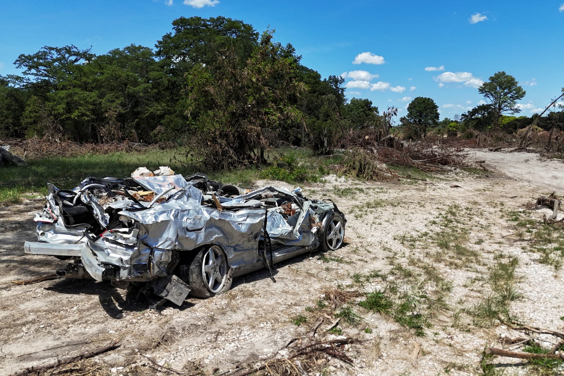 A drone view of a destroyed car near the Guadalupe River, in the aftermath of deadly flooding over the July Fourth weekend, in Ingram