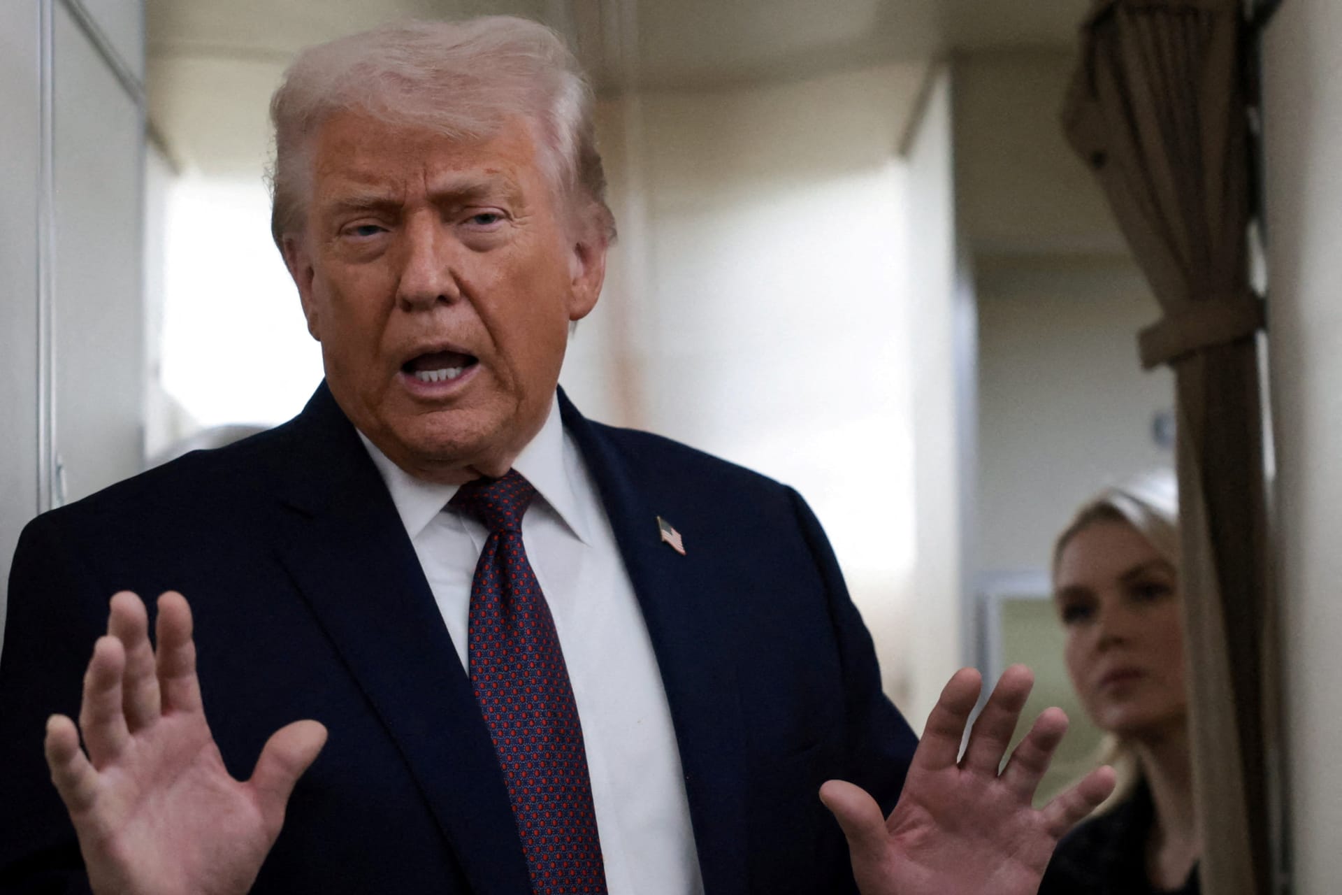 FILE PHOTO: U.S. President Donald Trump speaks to reporters aboard Air Force One