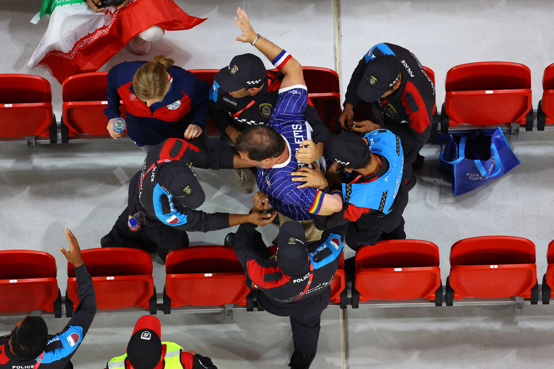 <p>DOHA: Police remove a fan wearing a rainbow-colored arm band from the stands at a FIFA World Cup game, on November 29, 2022.</p>

