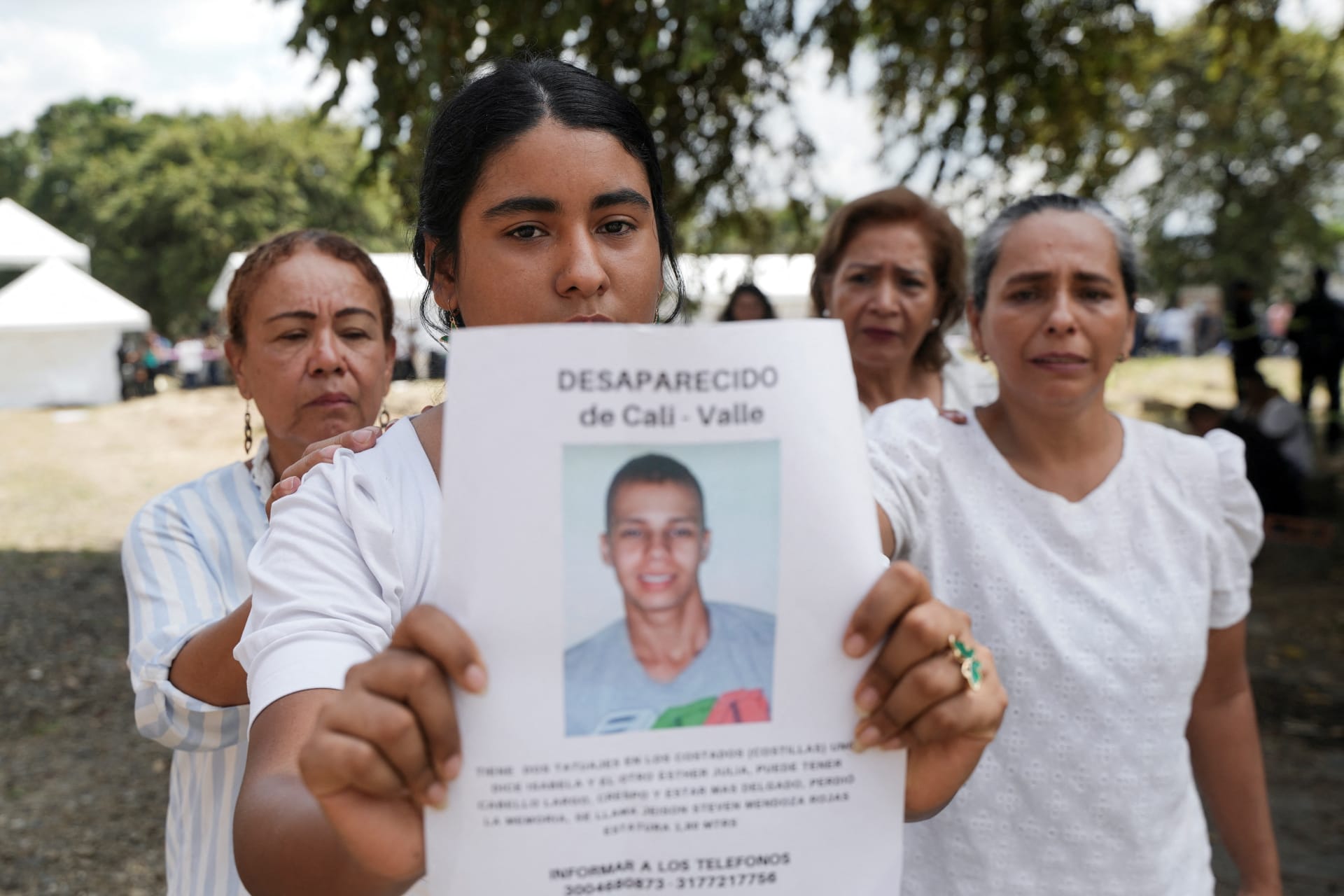 A woman holds a picture of a victim of forced disappearance during a 2025 ceremony in Colombia to honor loved ones who remain missing.