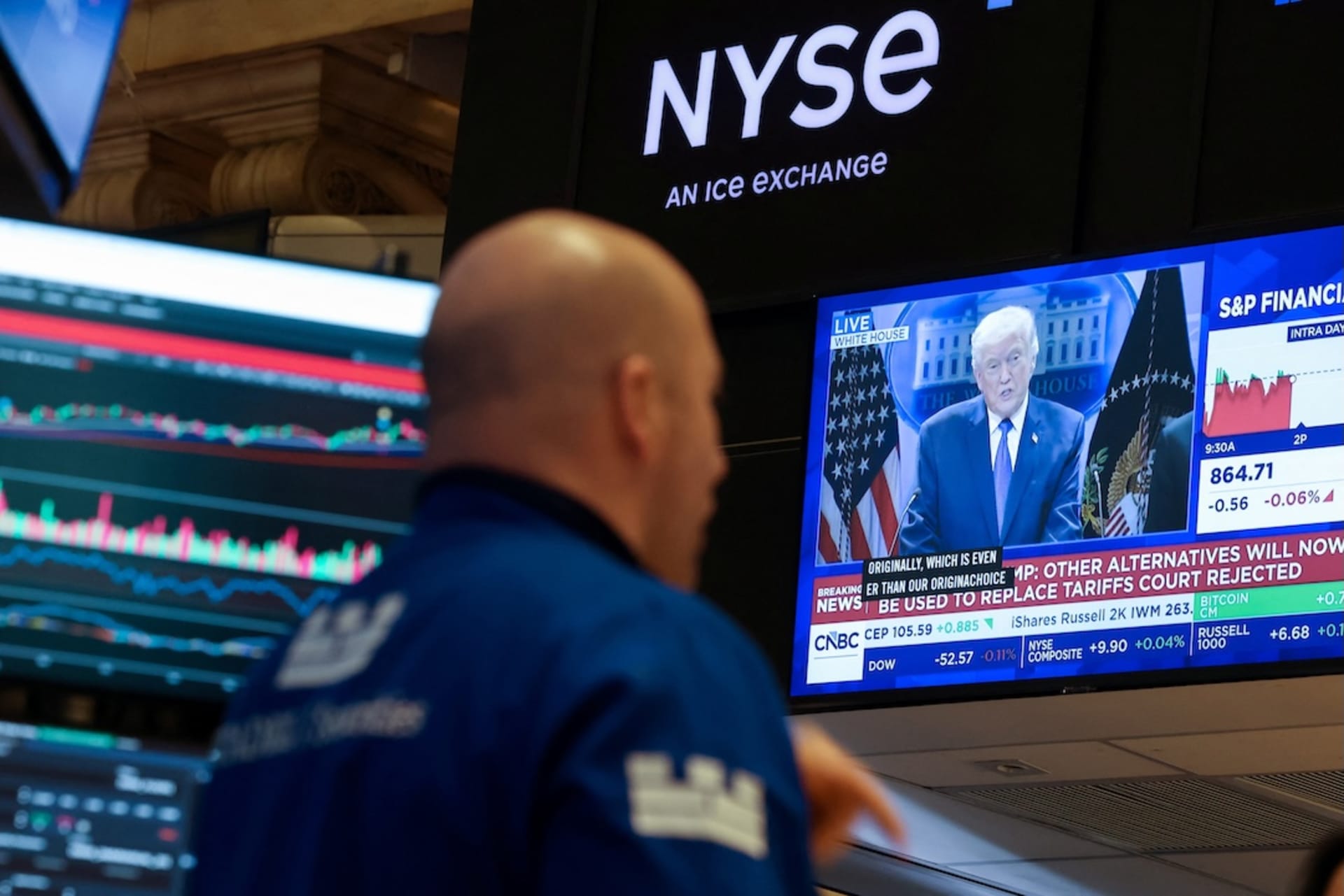 <p>A trader works on the floor, as a screen displays U.S. President Donald Trump during a press briefing at the White House following the Supreme Court’s ruling on tariffs, at the New York Stock Exchange (NYSE) in New York City, U.S., February 20, 2026.</p>
