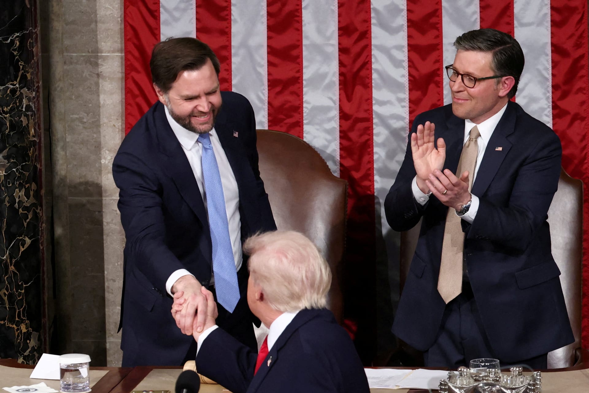 FILE PHOTO: U.S. President Donald Trump shakes hands with Vice President JD Vancei