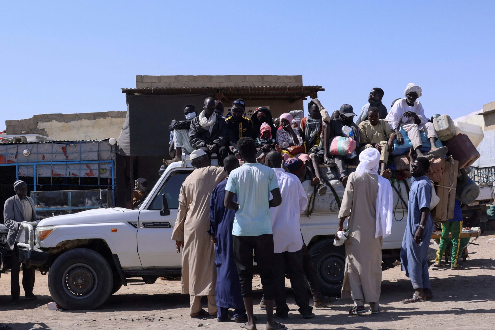 <p>People sit on a pickup truck as they prepare to travel about 250 kilometers south to Adré, on the Chad-Sudan border, at a transport station in Tine, eastern Chad, on November 25, 2025. The movement comes amid the ongoing conflict between the paramilitary Rapid Support Forces and the Sudanese army.</p>
