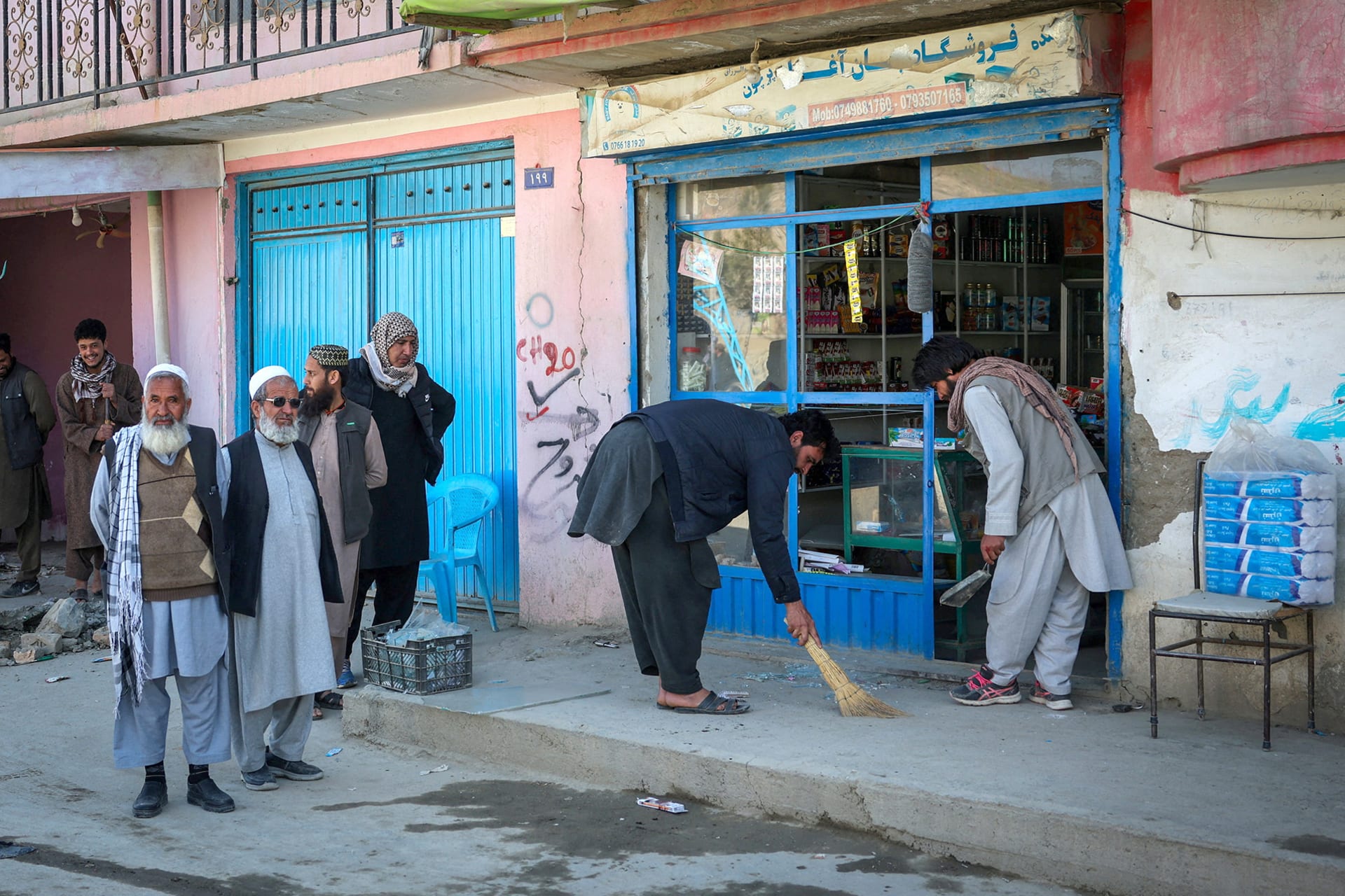 People remove shattered glass from their shop, following Pakistani airstrike, in the Darul Aman locality, in Kabul, Afghanistan, February 27, 2026.
