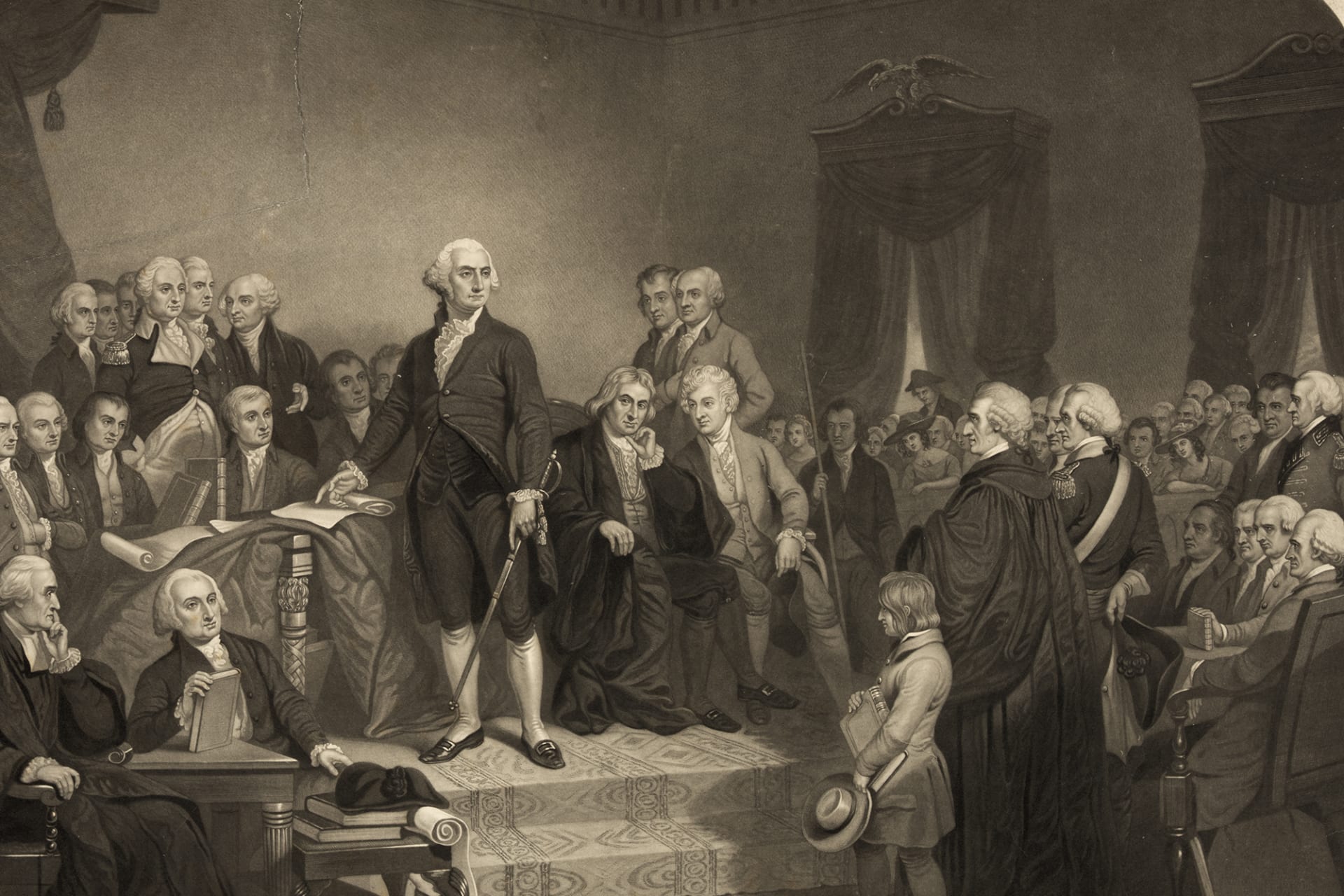 Black and white illustration of George Washington delivering speech in font of crowd of prominent men in old hall