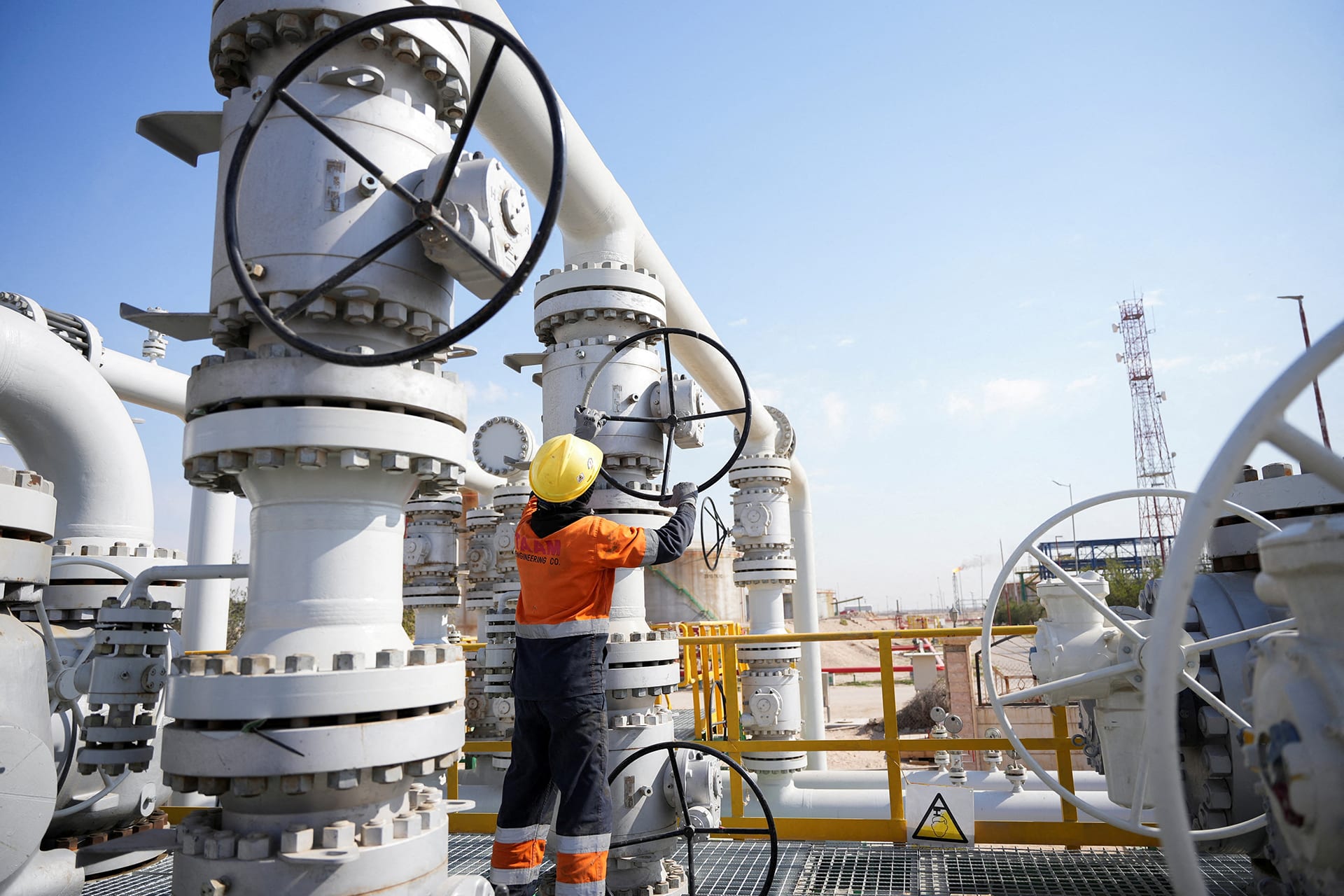 A worker operates valves at the Rumaila oil field, as the country cuts nearly 1.5 million barrels per day of output amid halted exports following the closure of the Strait of Hormuz, in Basra, Iraq, on March 4, 2026. 