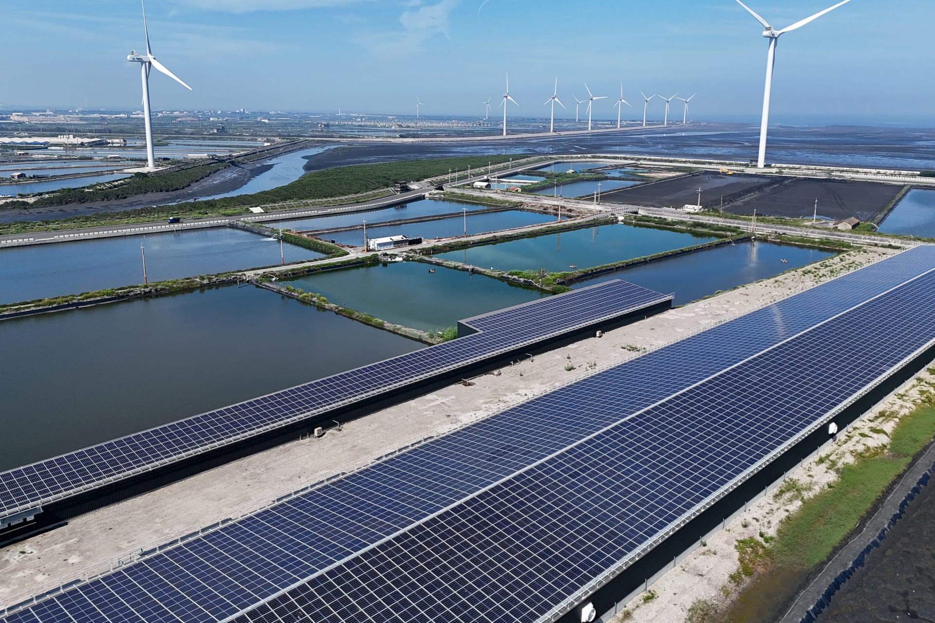 Wind turbines and solar panels are pictured in Changhua