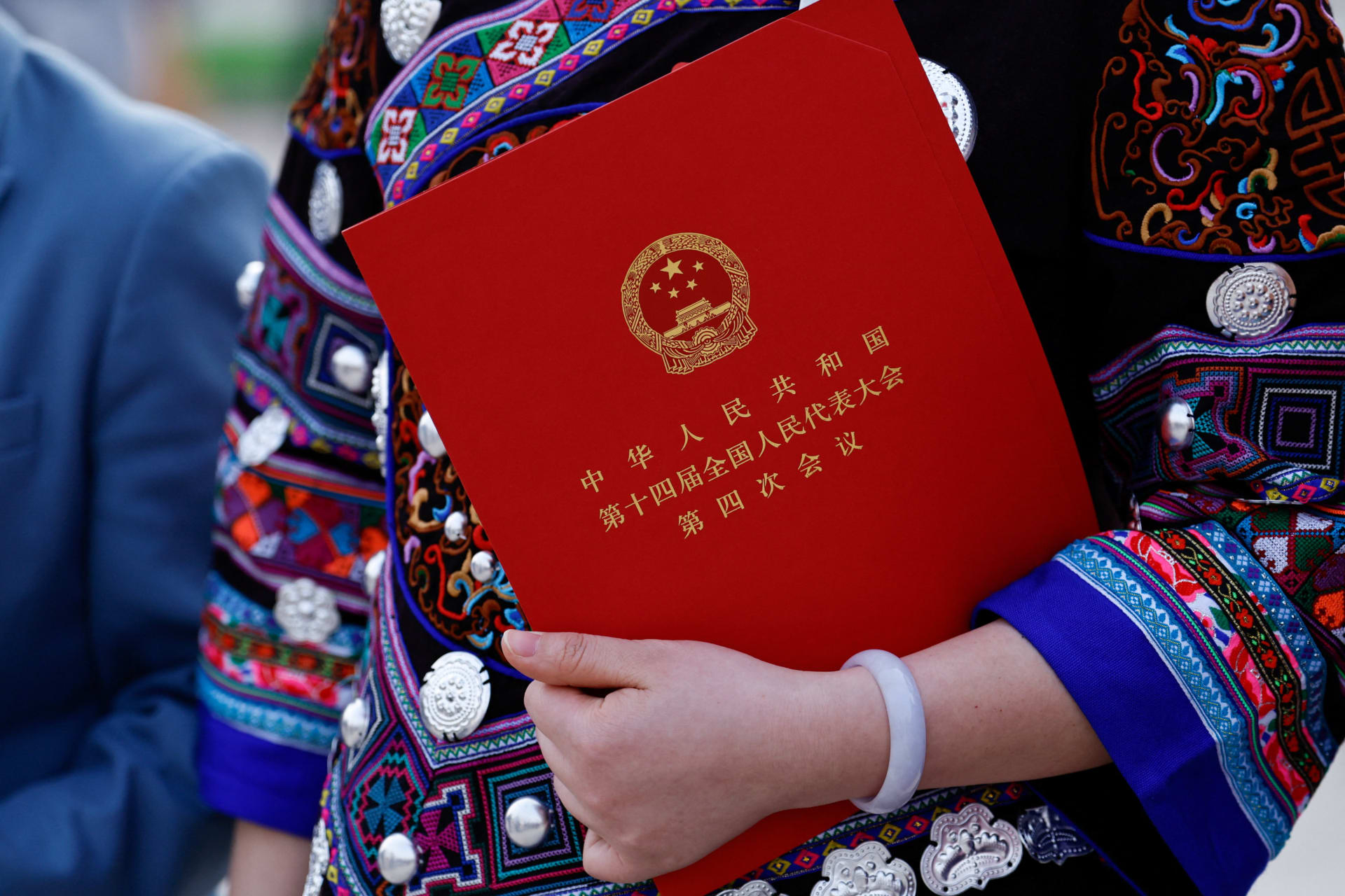 <p>A delegate in ethnic minority costume holds a document following the closing session of the National People’s Congress (NPC) at the Great Hall of the People in Beijing, China March 12, 2026.</p>
