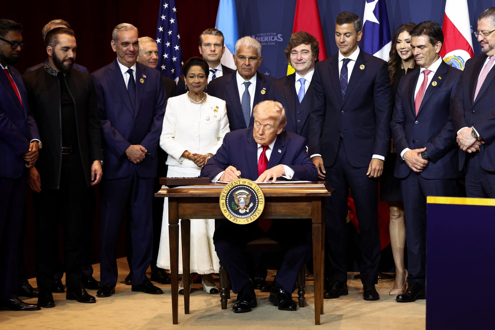 <p>U.S. President Donald Trump signs the “Commitment to countering cartel criminal activity” document during the “Shield of the Americas” Summit in Miami, Florida, U.S., March 7, 2026.</p>
