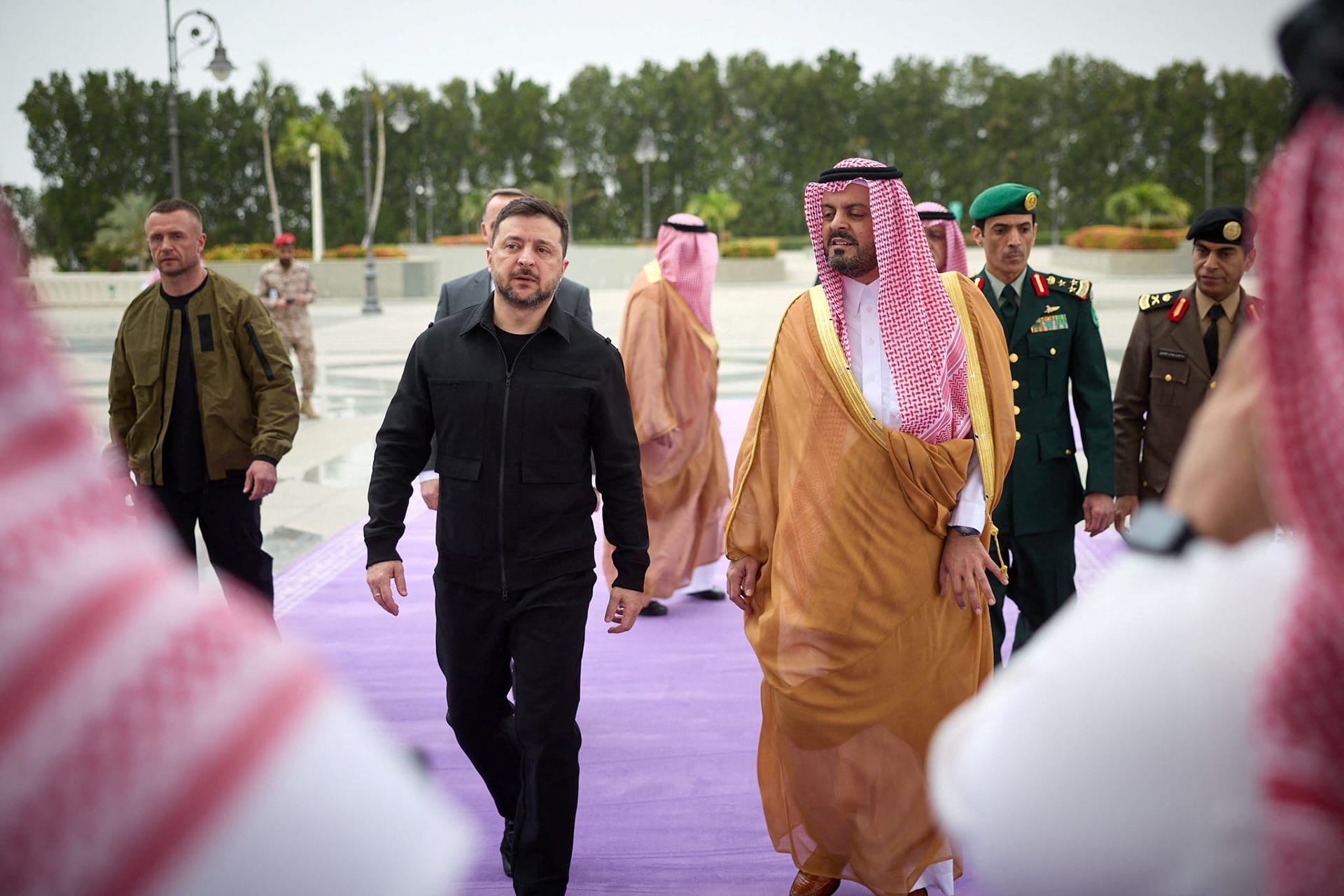 Ukraine's President Volodymyr Zelenskyy walks outdoors with Deputy Governor of Makkah Region Prince Saud bin Mishaal bin Abdulaziz during his visit to Jeddah, Saudi Arabia.